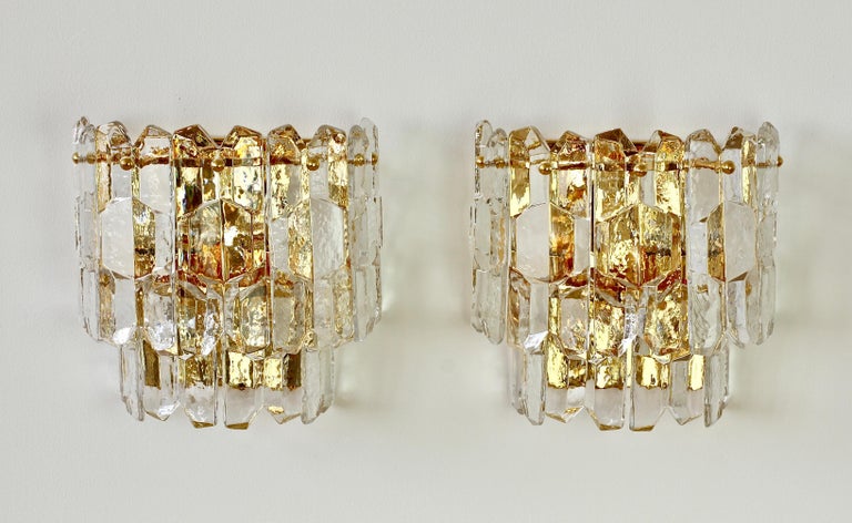 Austrian made 'Palazzo' ice crystal glass wall sconces or lights by Kalmar, circa 1960. Featuring nine hanging glass elements resembling melting ice crystals suspended from a 24-karat gold plated brass mount or bracket.

Can be used with original