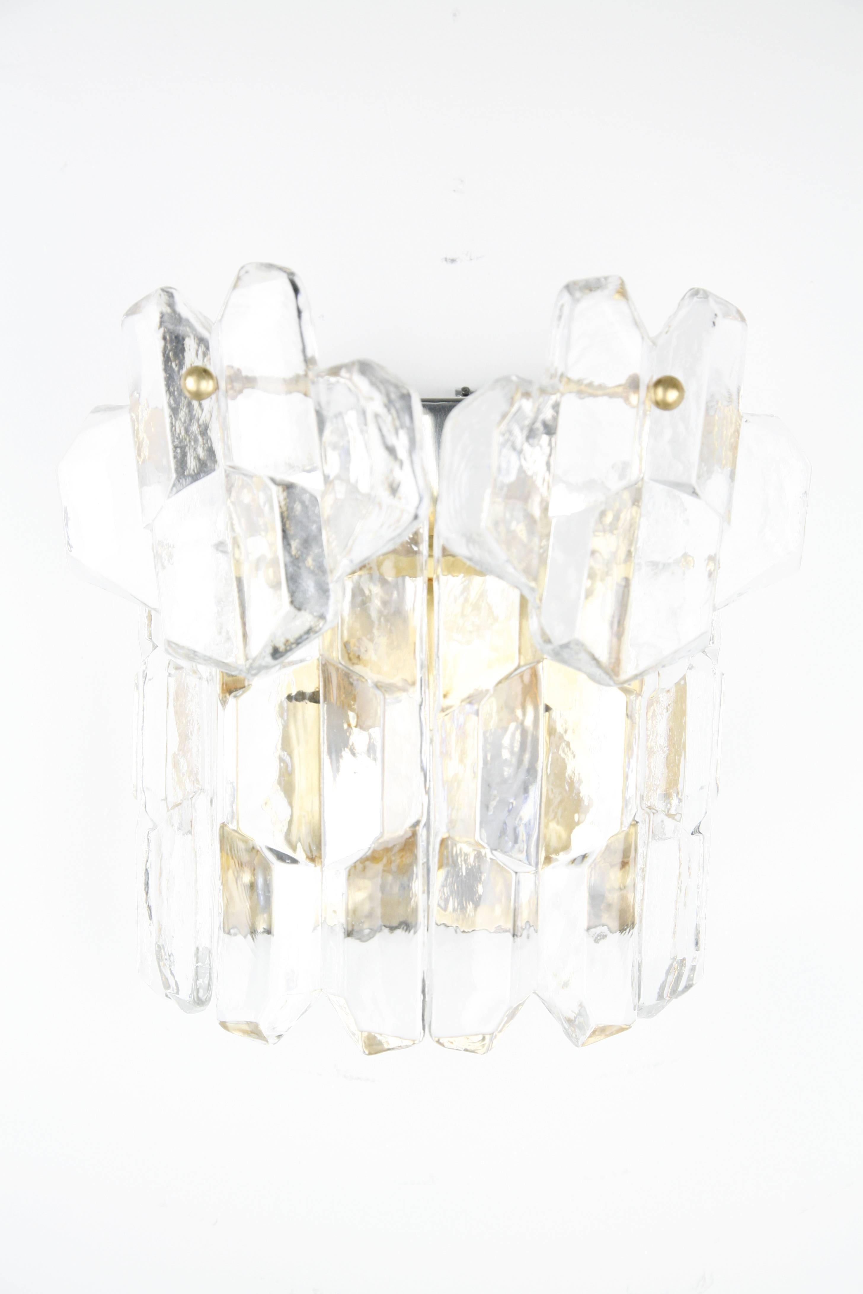 A single Kalmar palazzo crystal sconce 1970s Vienna Austria, six thick clear heavy pieces of crystal on a chrome frame that is 24-carat gilt, the frame has been polished over time so the chrome shine through behind the glass which is not visible