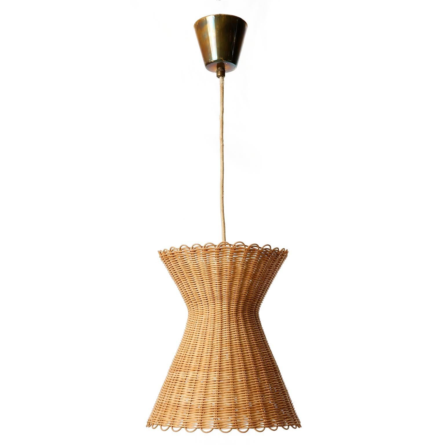A rare pendant light model 'Kiwi', no. 3202 by J.T. Kalmar, Vienna, Austria, manufactured in Mid-Century, circa 1960 (1950s or early 1960s).
A wickerwork lamp shade on a cord and patinated brass canopy.
The wicker is in excellent original