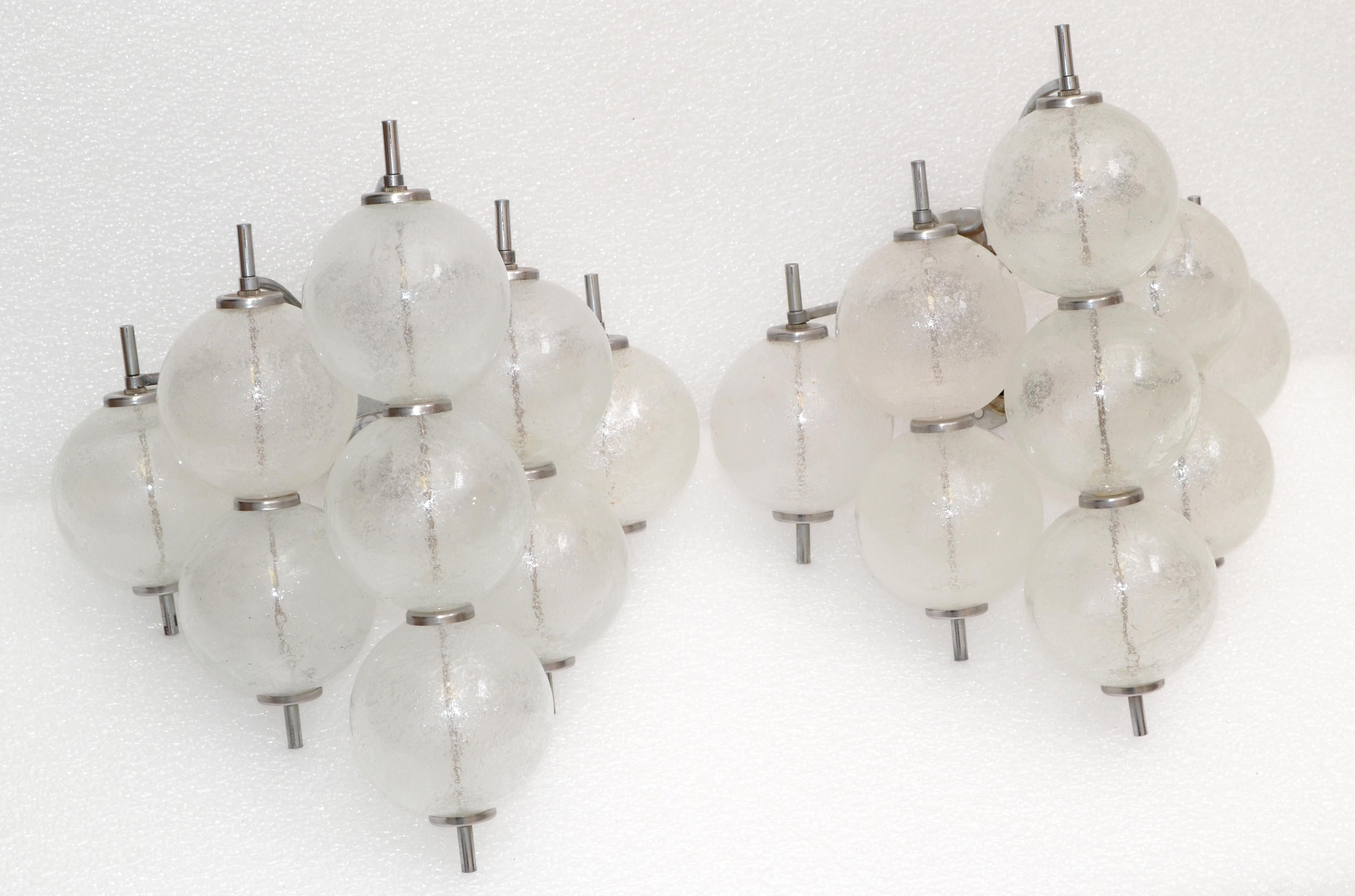 Pair of Kalmar Sconces, Tulipan model, wall Lights made out of blown bubbles glass and are mounted on a nickel frame in form of a grape.
Made in Vienna, Austria in the late 1960s.
Each sconce takes 1 light bulb max. 40 watts.
Back plate measures: