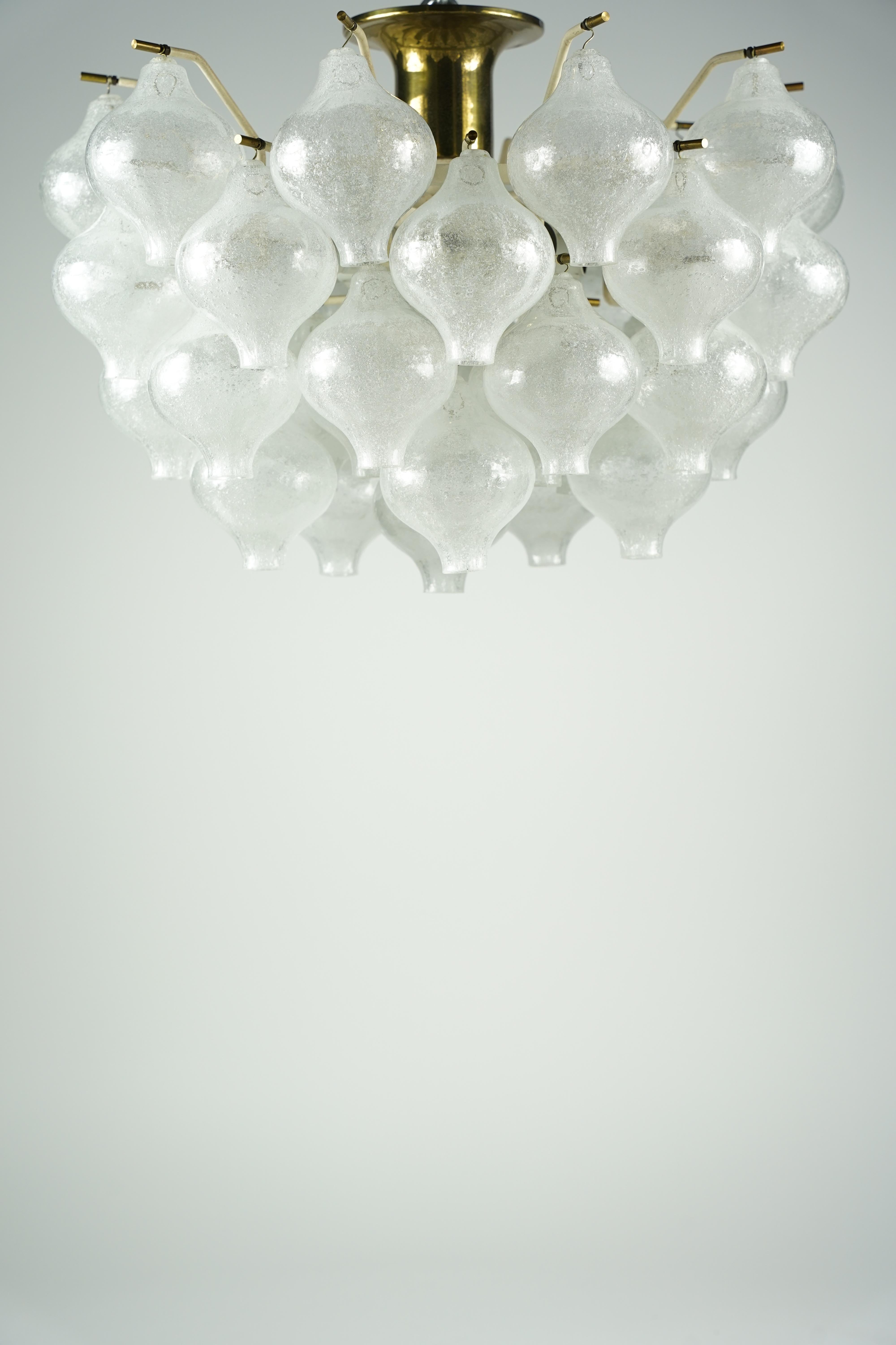 Kalmar Tulipan semi flush mount, Vienna Austria 1960, Numerous blown glass elements which are highly saturated with tiny air bubbles , The glass elements are held by brass finials on a white metal frame with a brass canopy that is flush to the