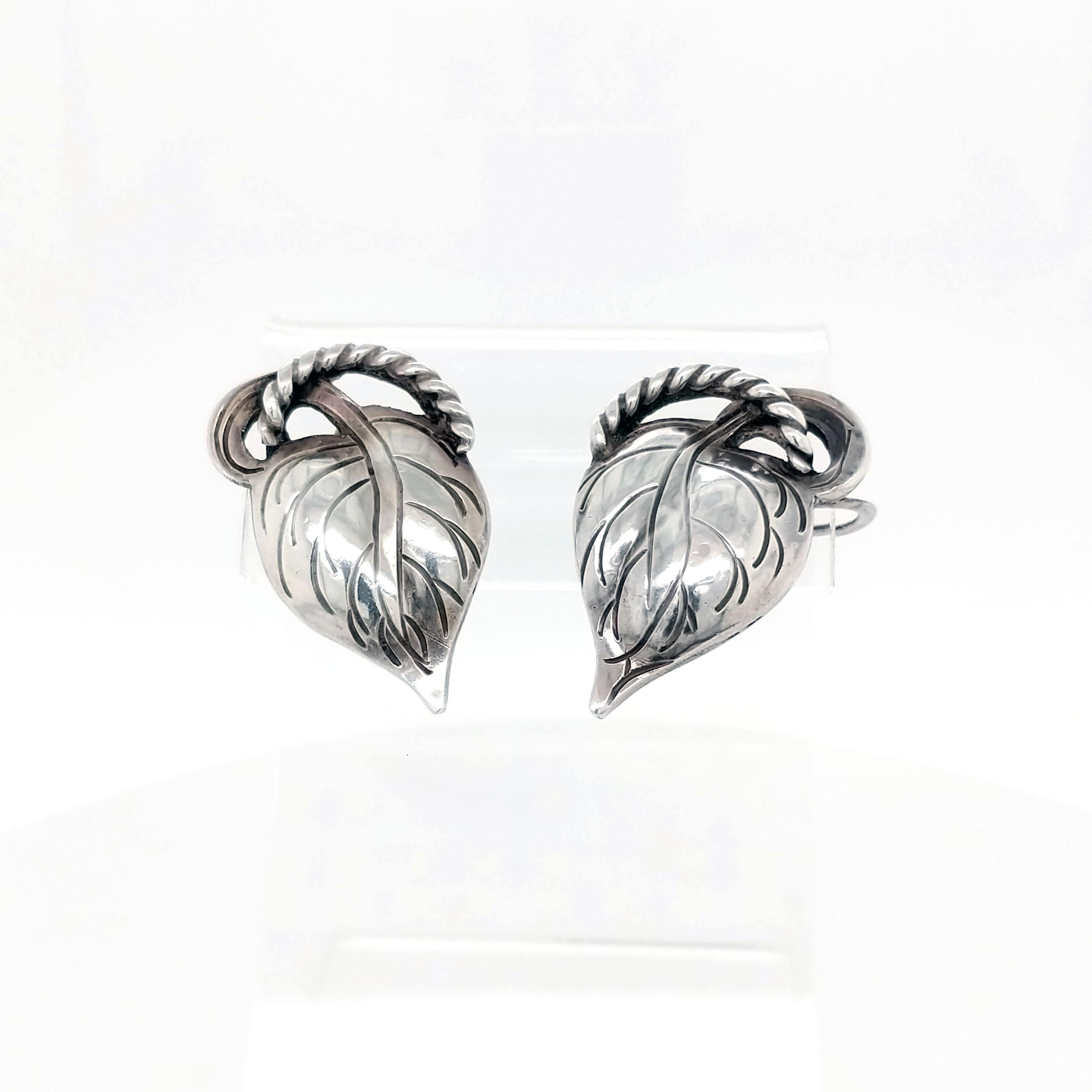 These earrings are lovely! Made by Kalo, the most prominent maker of Arts & Crafts style jewelry in Chicago in the early 1900s, these sterling silver leaves are sure to perfectly frame your face and compliment any outfit you pair them with! These