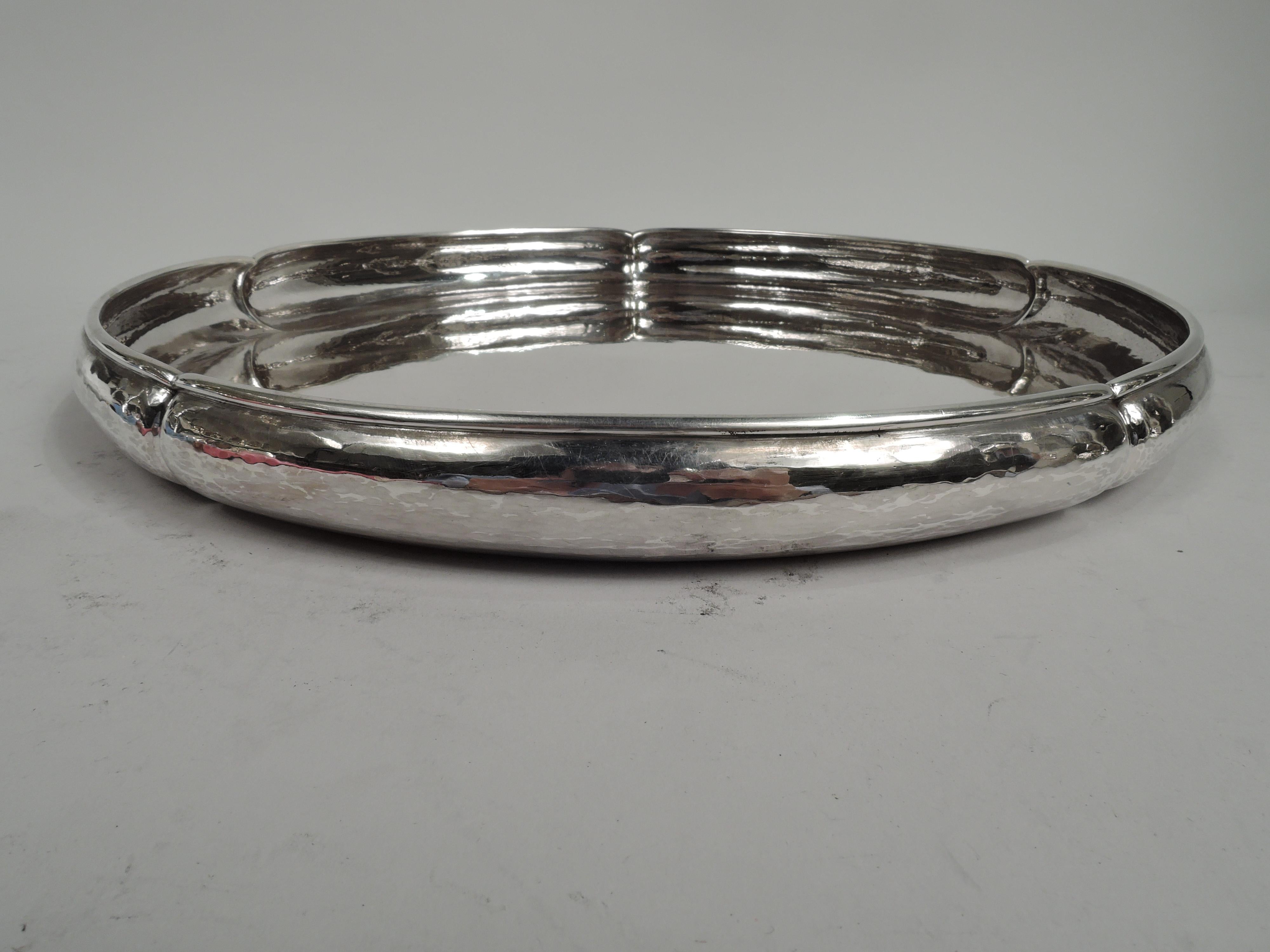Craftsman sterling silver petal tray. Made by the Kalo Shop in Chicago, ca 1940. Plain and round well with curved and lobed hand-hammered sides. Nice heft with plenty of room for the appetizers. For table or buffet. Marked “Sterling / Hand Wrought /