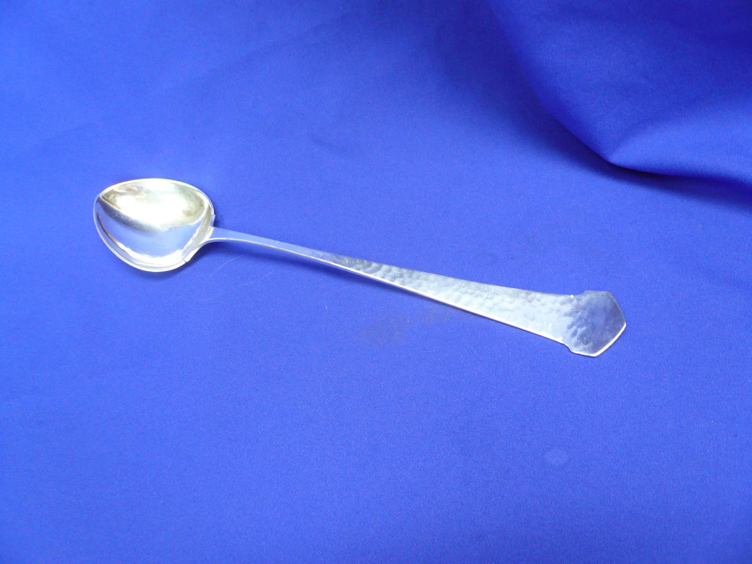 Antique Arts & Crafts design sterling silver long handled serving spoon by the
Kalo Shop of Chicago.  Known for 70 years of quality and hand wrought design, Kalo was a critical in the Arts & Crafts movement. 
Spoon features hammered design with