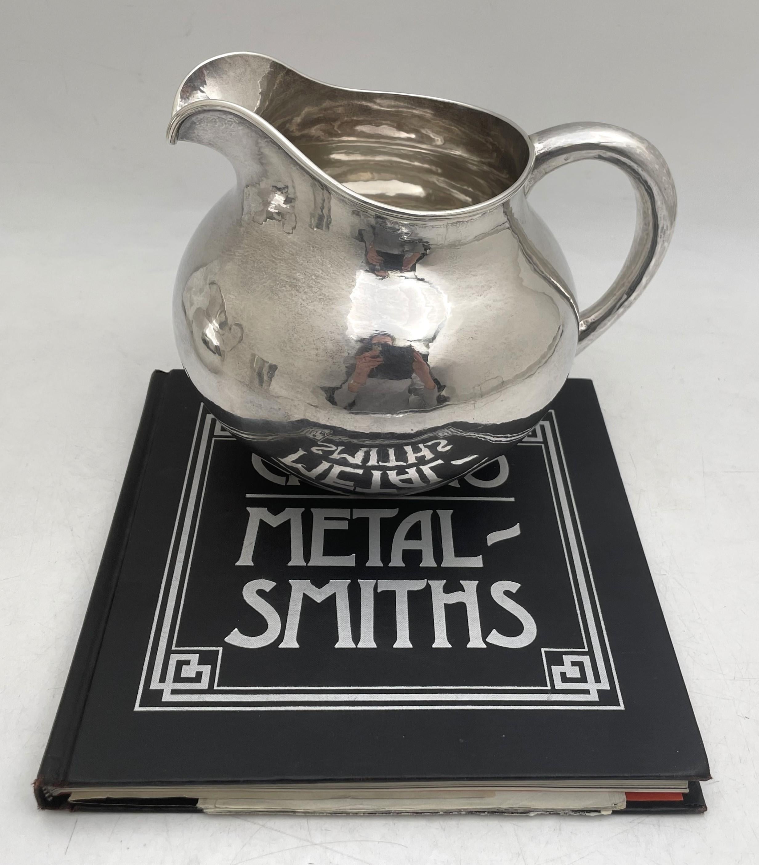 The Kalo Shops, sterling silver beautifully hand wrought pitcher in Arts & Crafts style in an elegant, curvilinear design made between 1912 and 1916. It measures 7'' in height by 8'' from handle to spout, weighs 19.8 troy ounces, and bears hallmarks