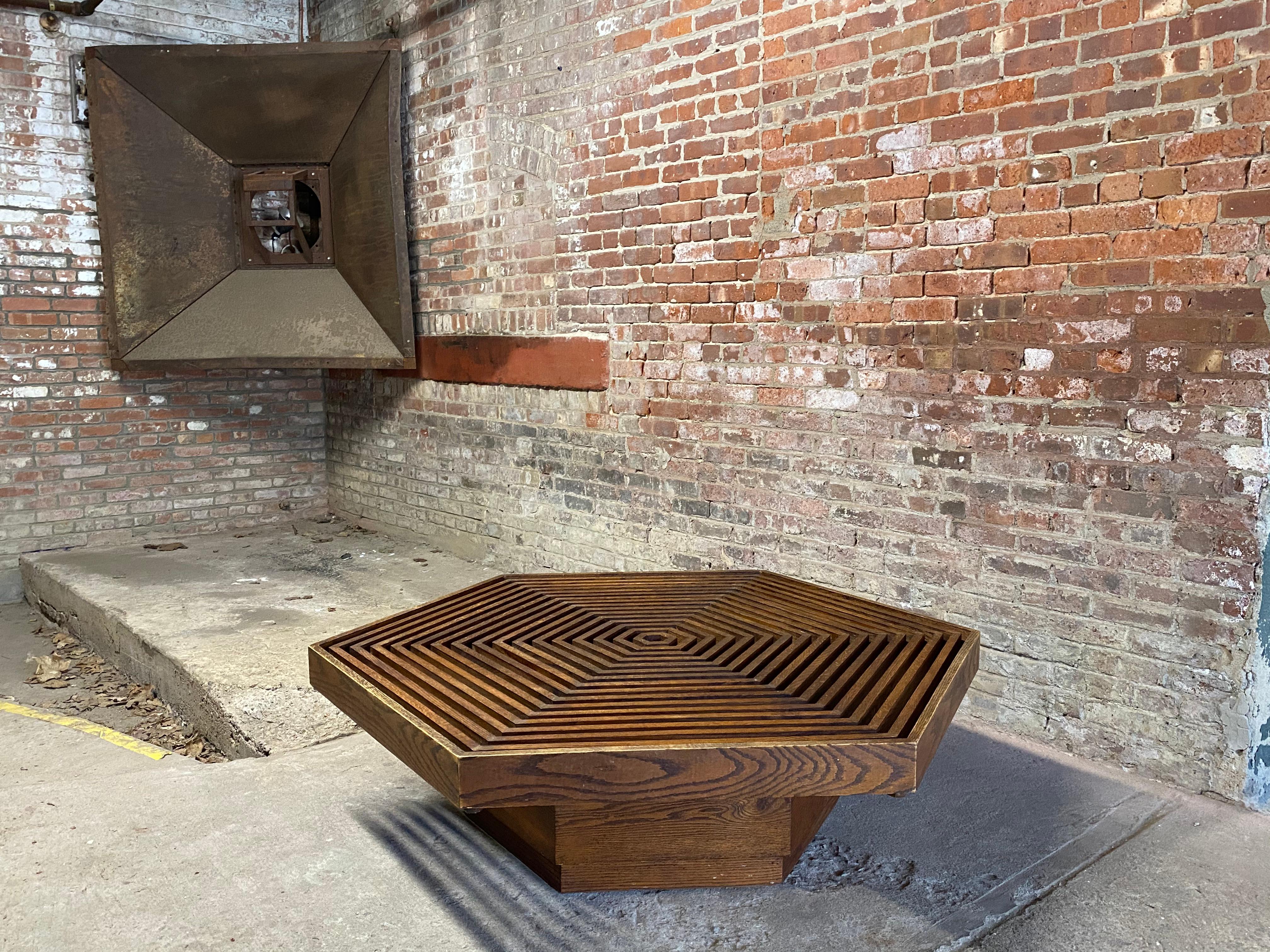 Kamal Amin ( 1928-2020) was a disciple and assistant to Frank Lloyd Wright for eight years. He designed and produced this wonderful oak hexagonal coffee table done in the manner of his former boss. The table was purchased from the client's daughter