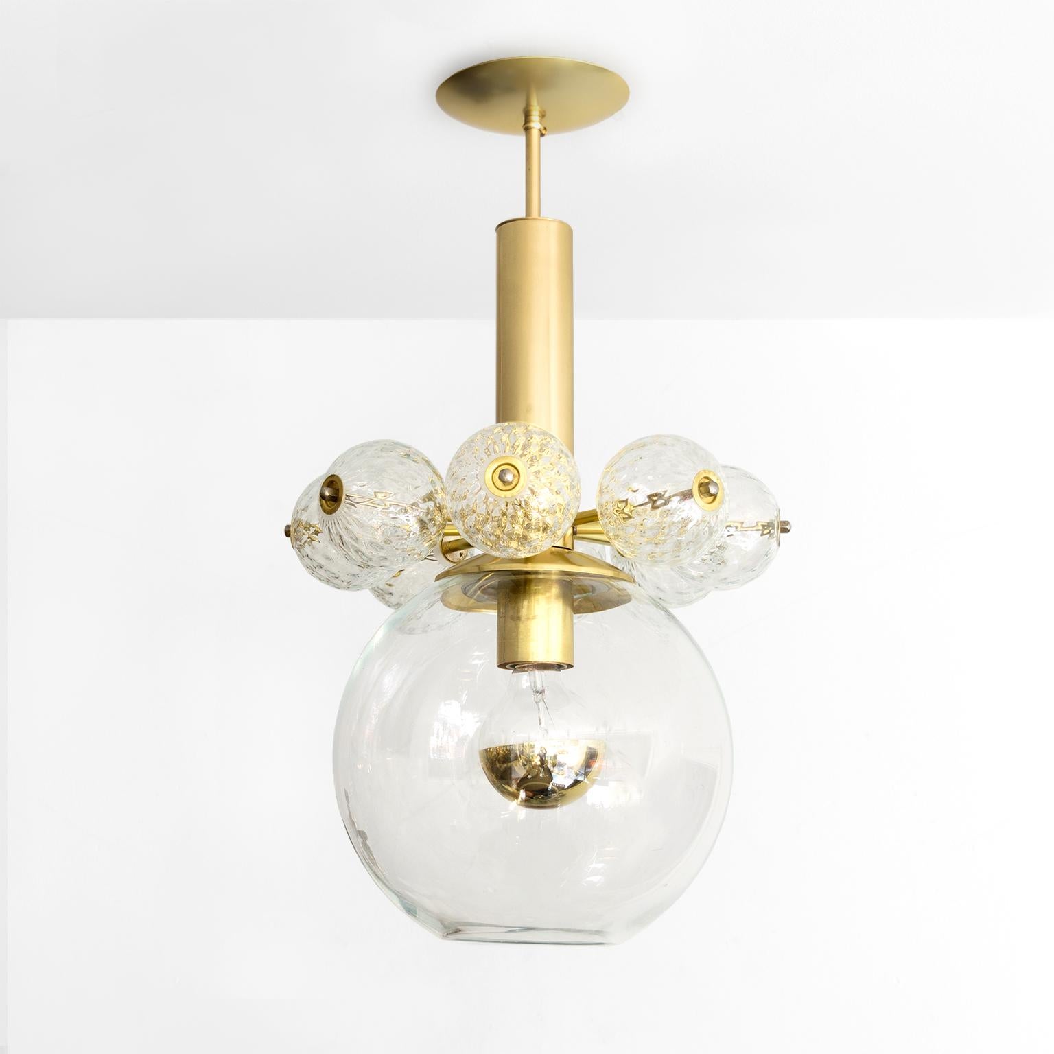 Kamenicky Senov, Czech pendant with hand blown glass on a polished brass frame. The fixture has a collar of clear glass crystal globes which rests atop a larger glass shade. Newly restored, polished and lacquered brass, newly rewired for use in the