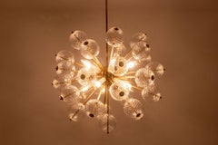 Kamenicky Senov, published by. Brass and glass chandelier. Circa 1970.