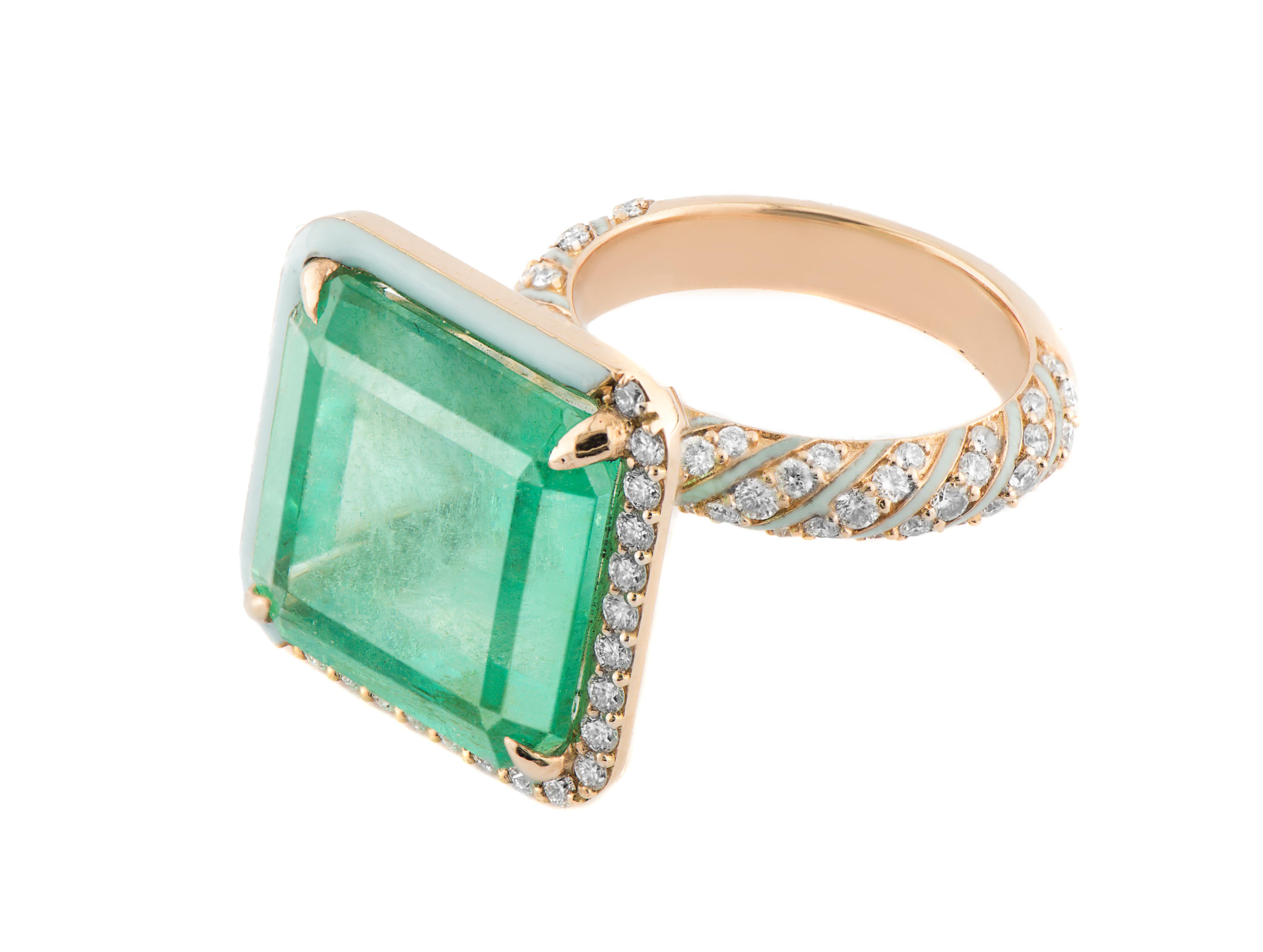 15.44 carat natural Zambian Emerald, encased with 2 sides of Enamel and a pave diamond border. With extra detailing with white enamel stripes and pave diamond stripes. This ring is in 2.64 grams of 18K rose gold.

