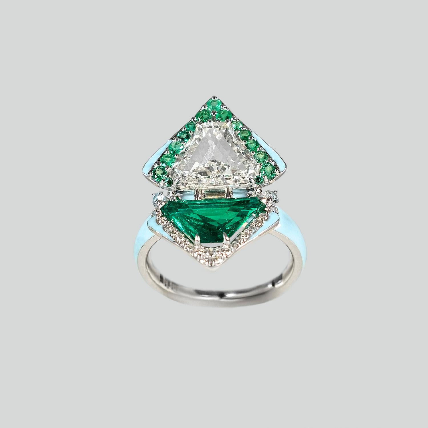 2.00 Carat each Colombian Emerald & Diamond Paired Shield Cut Ring. Accented with contrasting Pave setting diamond and Emeralds. Made with 6.55 grams of 18K White Gold.

This is a one-of-a-kind Kamyen Piece!