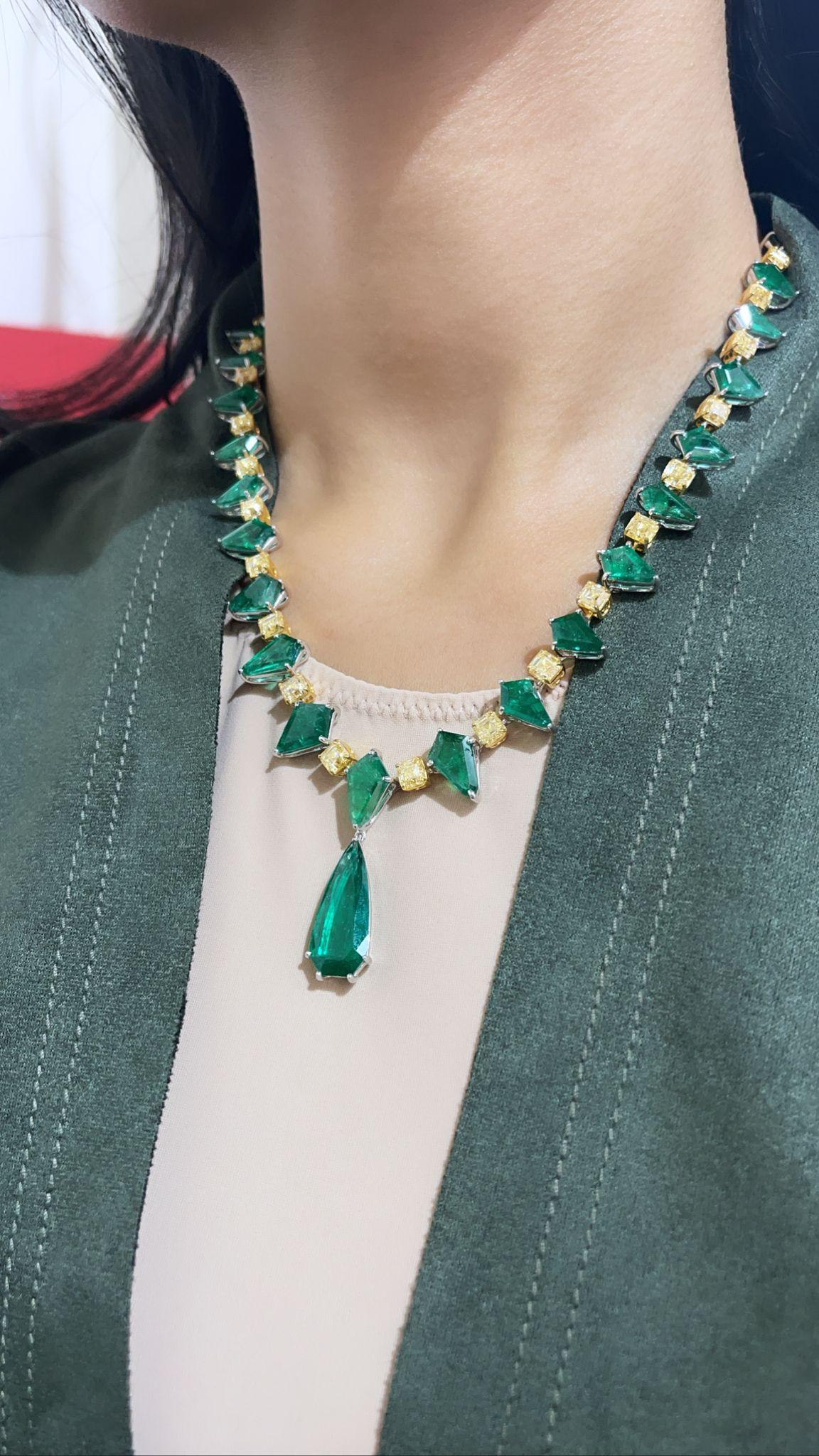Specially Curated piece of graduating 33.74 Carats  of Kite shape Zambian Emeralds and 18.38 Carats Yellow Cushion Diamonds with a 6.94 Carat Zambian Emerald Pear shape drop! Made with 43.70 grams of 18K Yellow Gold. This piece was crafted by highly