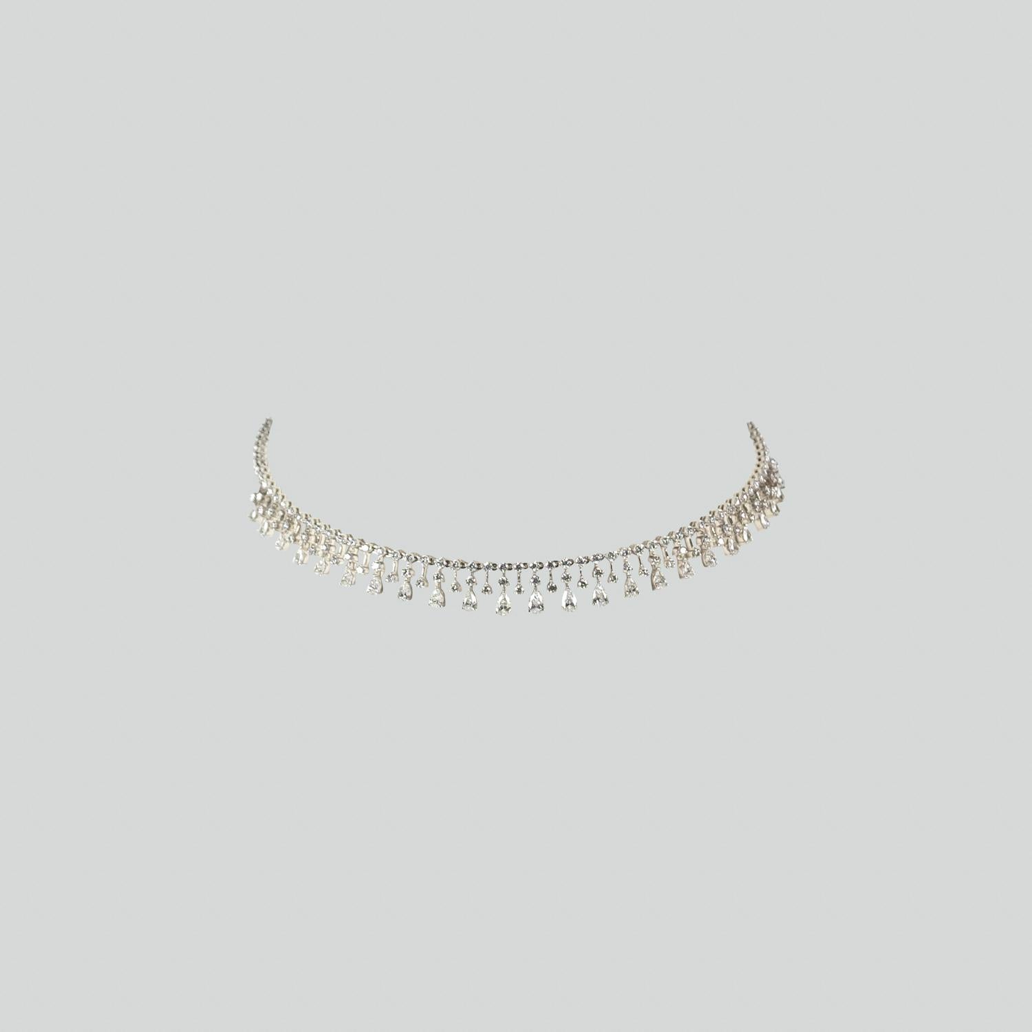 Graduating pear shape diamonds from 0.25 carats to 0.10 carats, in combination with 0.05 carat round diamonds. This choker is made in 18k white gold, and has a self adjustable ball chain mechanism. 

Kamyen's Classic Pret-a-Porter Choker!