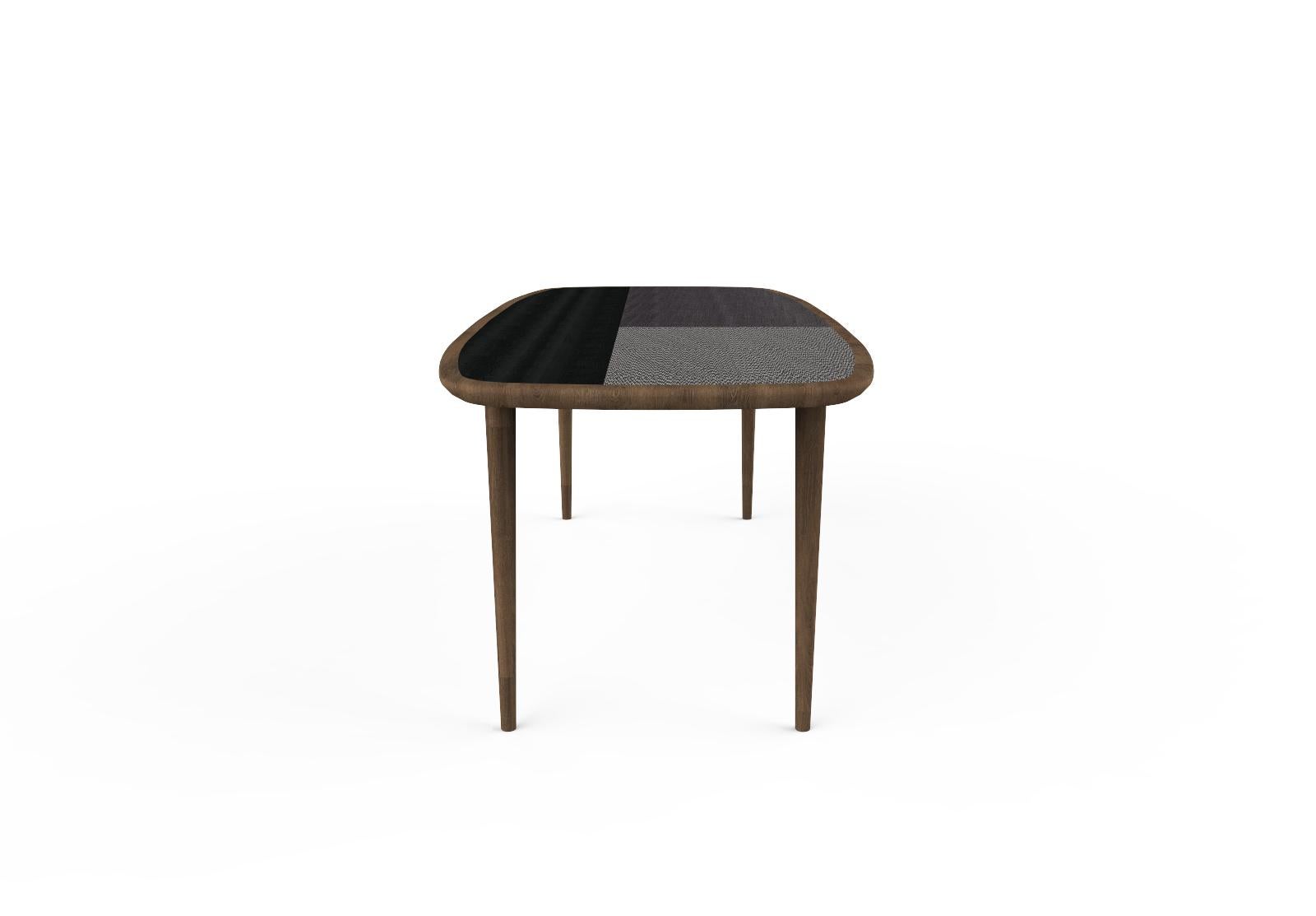 Dinner table in walnut Canaletto and legs in solid walnut Canaletto walnut and top in fabric-effect wood finish. The top can be made in one single finish or with contrasting background.