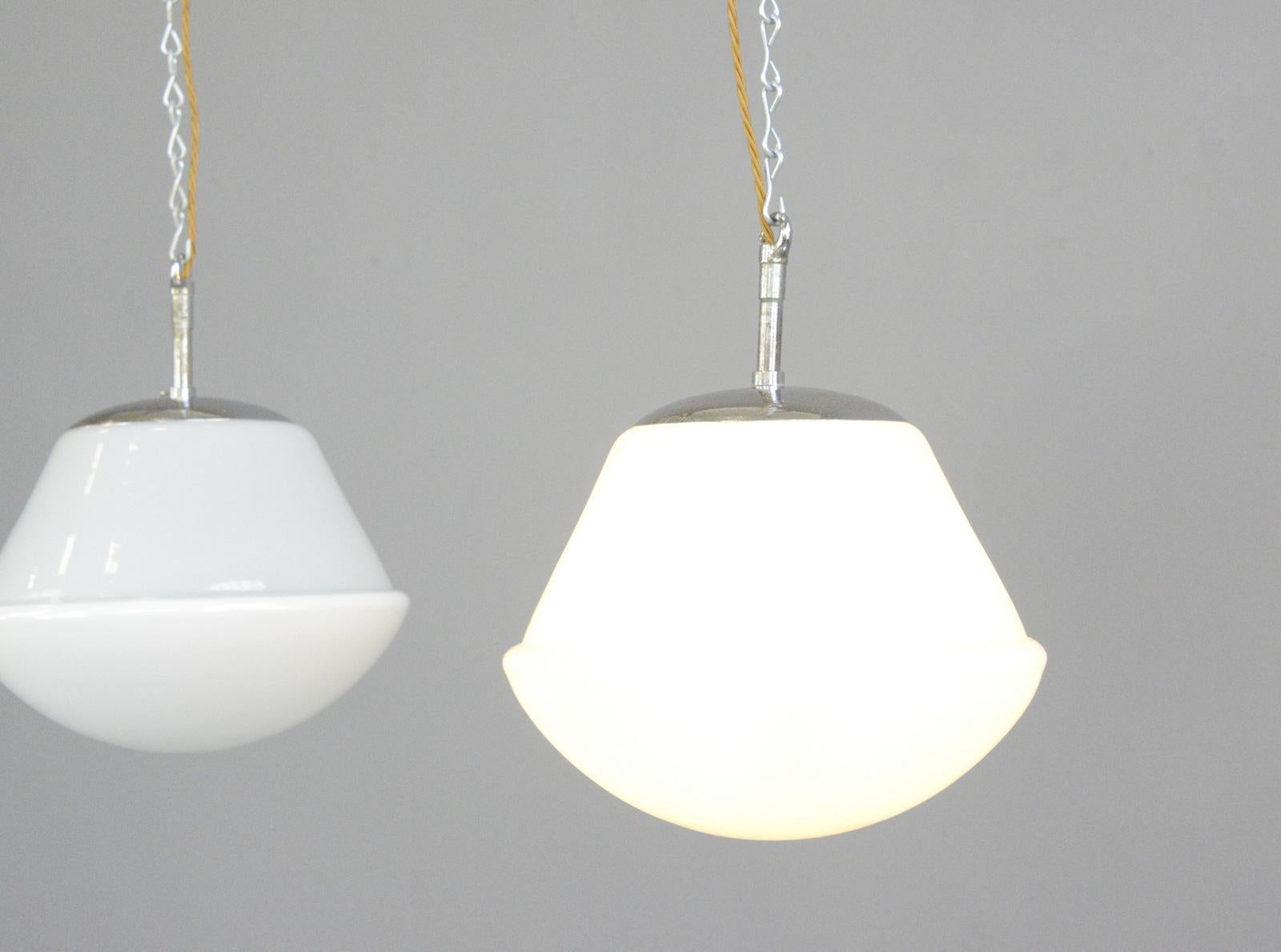 Kandem model 755 P40 opaline pendant lights, circa 1930s

- Price is for the pair
- Bell jar with a satin-finished upper half and a thickly opal-lined lower half
- Chrome tops
- Takes E27 fitting bulbs
- Marked 