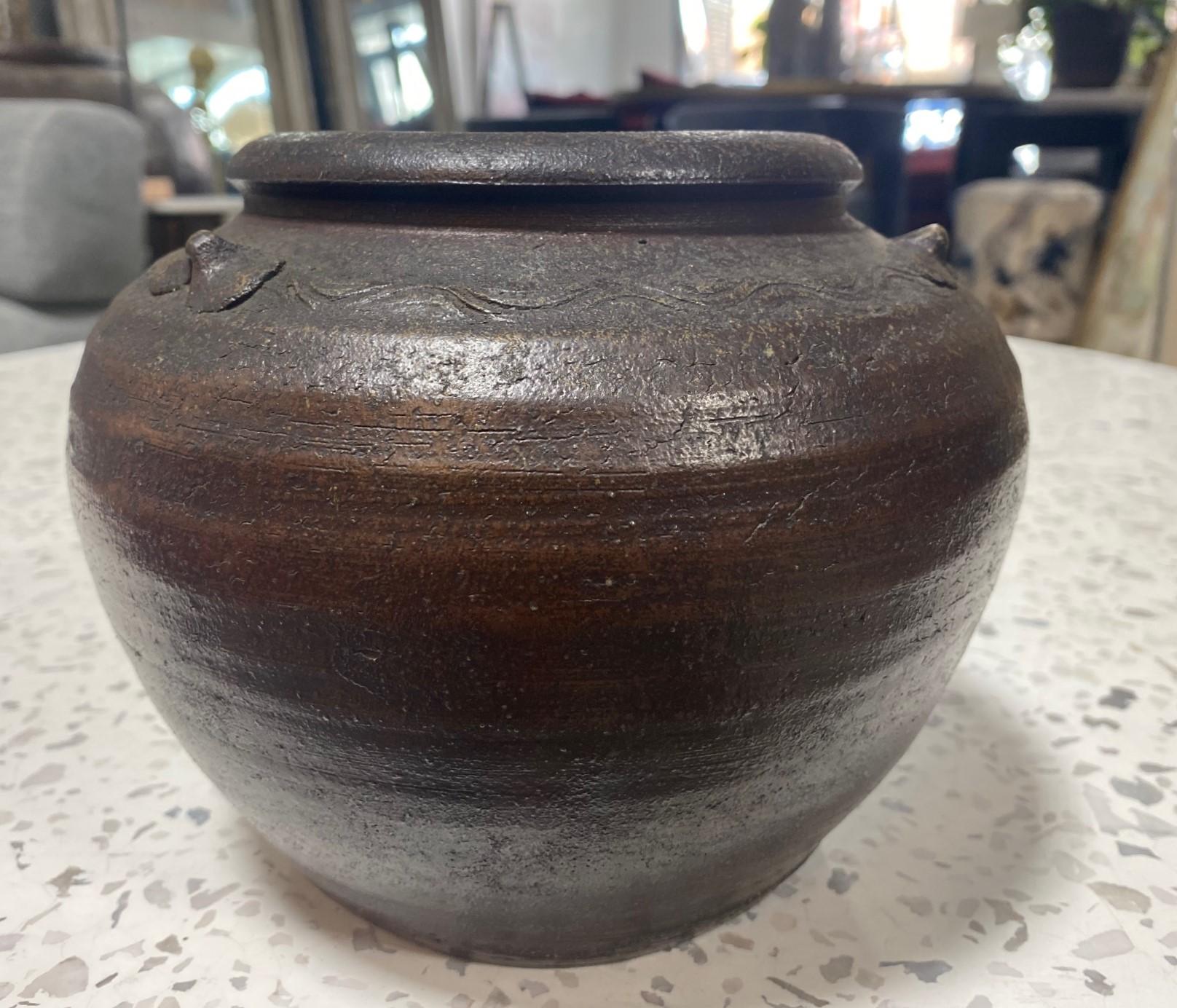 A beautiful, darkly fired, antique Bizen ware three-ear tsubo jar/pot/vase by renowned Japanese master potter/artist Kaneshige Toyo (1896-1967) featuring a line of hand-incised shoulder waves and light natural organic forming ash glaze. Kaneshige is