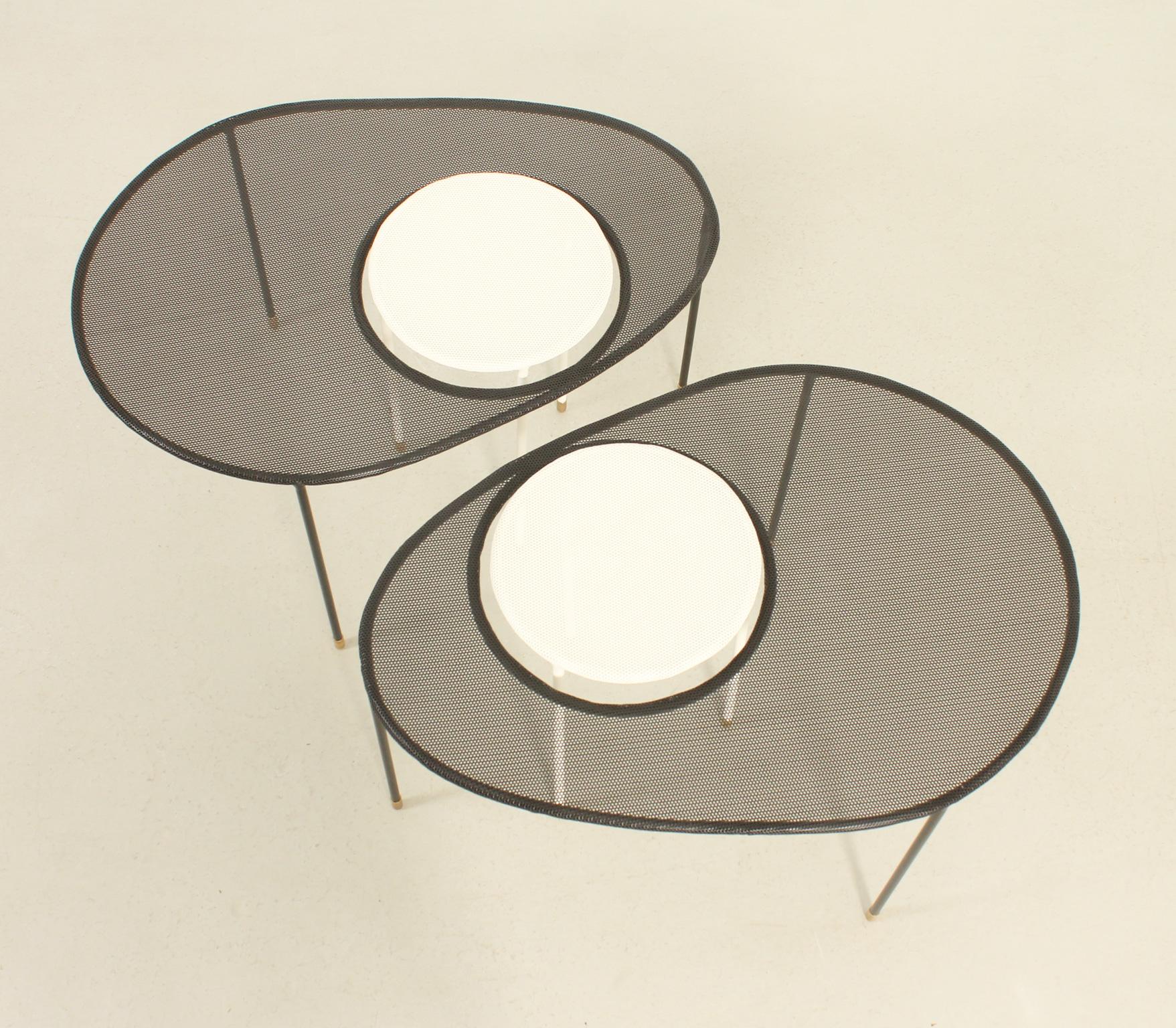 Kangouru coffee table designed in 1954 by French designer Mathieu Matégot and edited by Gubi in 2000's. Metal and perforated metal sheet lacquered in black and white with brass feet. Two pieces available.