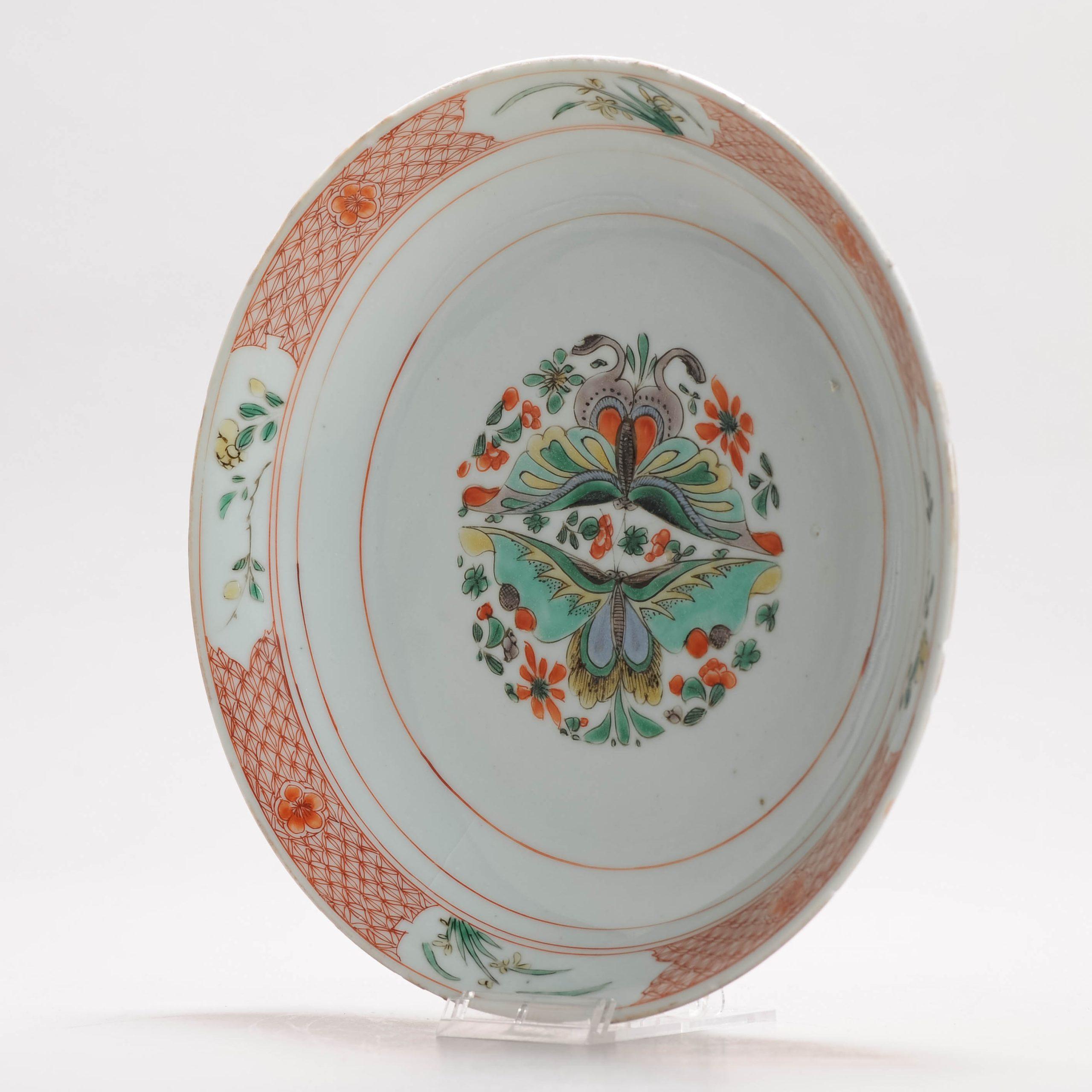 Sharing with you this amazing and unusual deep dish from the Kangxi period. In famille verte palette with a beautiful central scene of butterflies.

The border with geometric design in copper red and 4 compartments with flowers and reed.

The dish