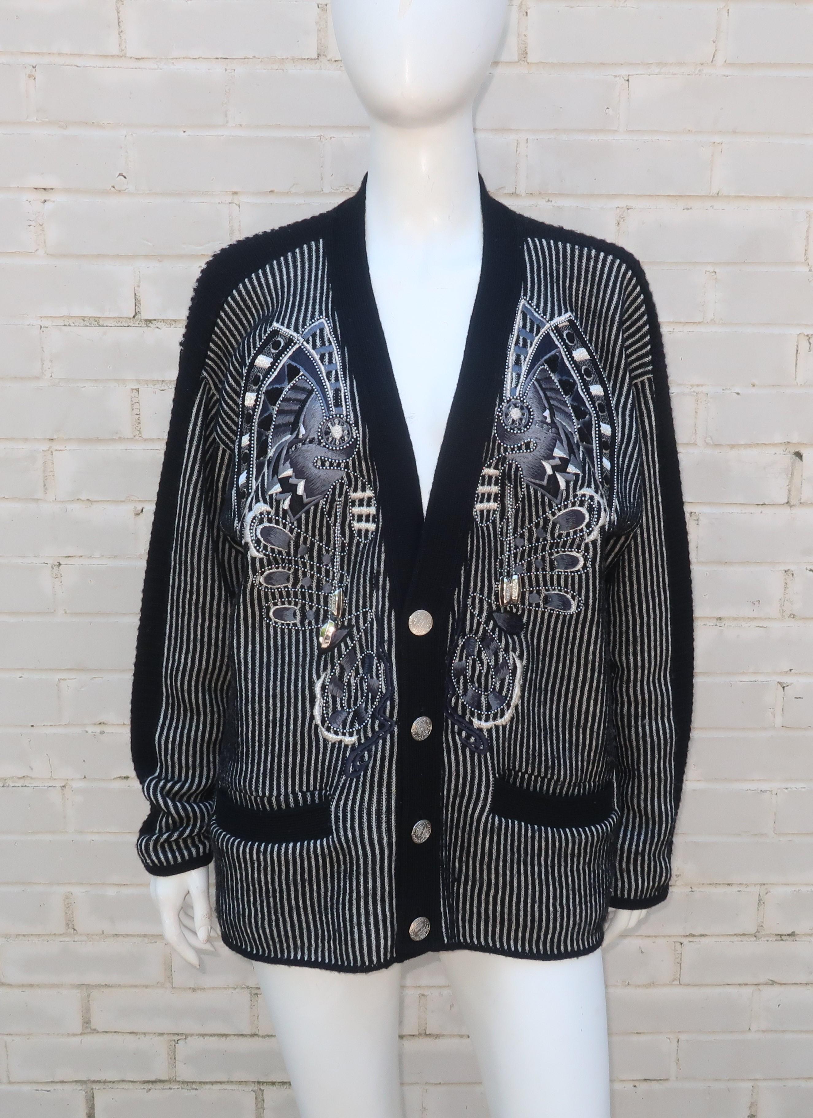 Black and white striped wool cardigan sweater with abstract embroidered decoration, silver metallic threading, dangling 'Kansai' silver charms, ball bearing style beading and logo embossed buttons by Japanese designer, Kansai Yamamoto.  Yamamoto was