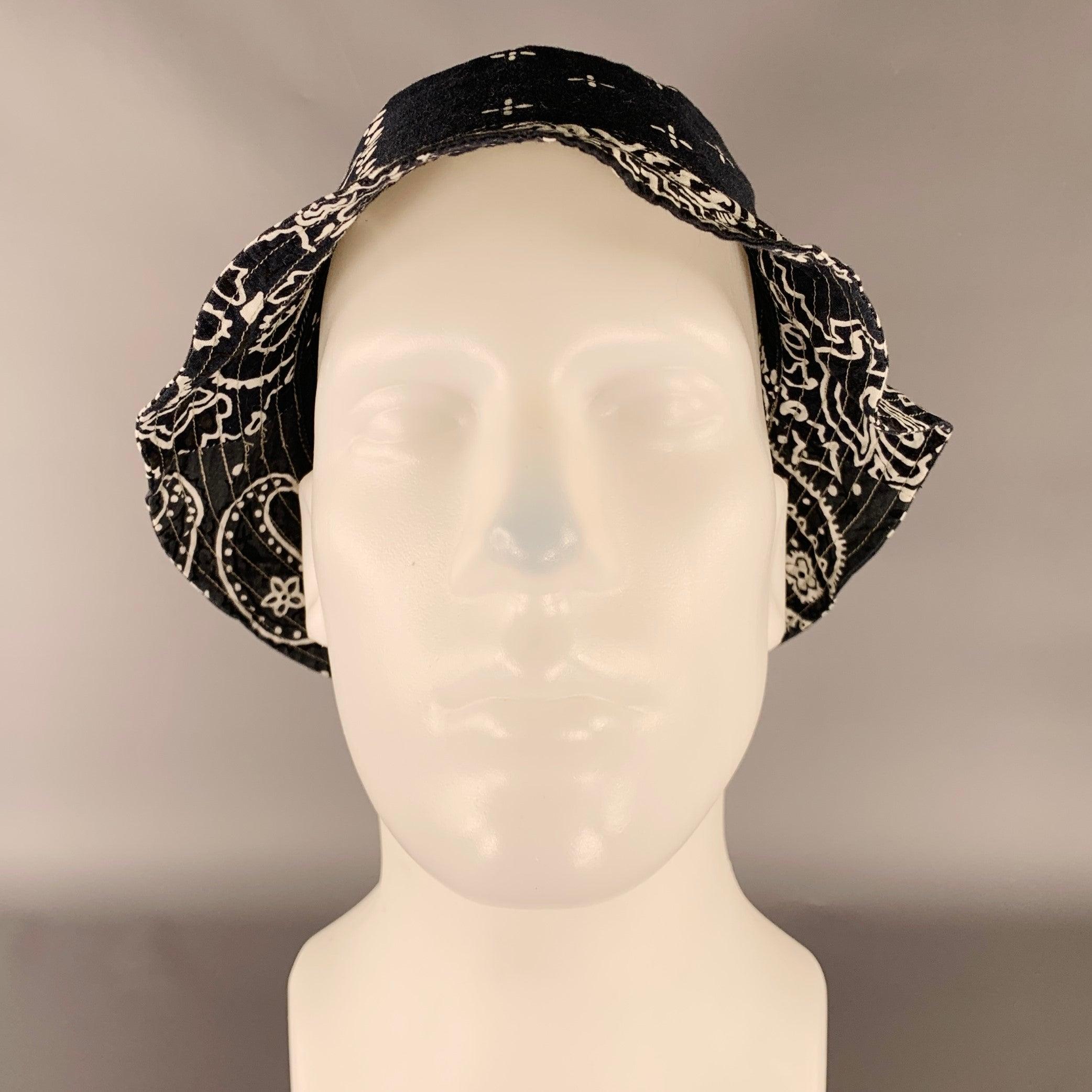 KAPITAL
hat in a black and white cotton blend fabric featuring a bucket style, bandana design, and mesh lining. Made in Japan.Excellent Pre-Owned Condition. 

Marked:   OS 

Measurements: 
  Opening: 20 inches Brim: 2 inches Height: 5 inches 
  
 