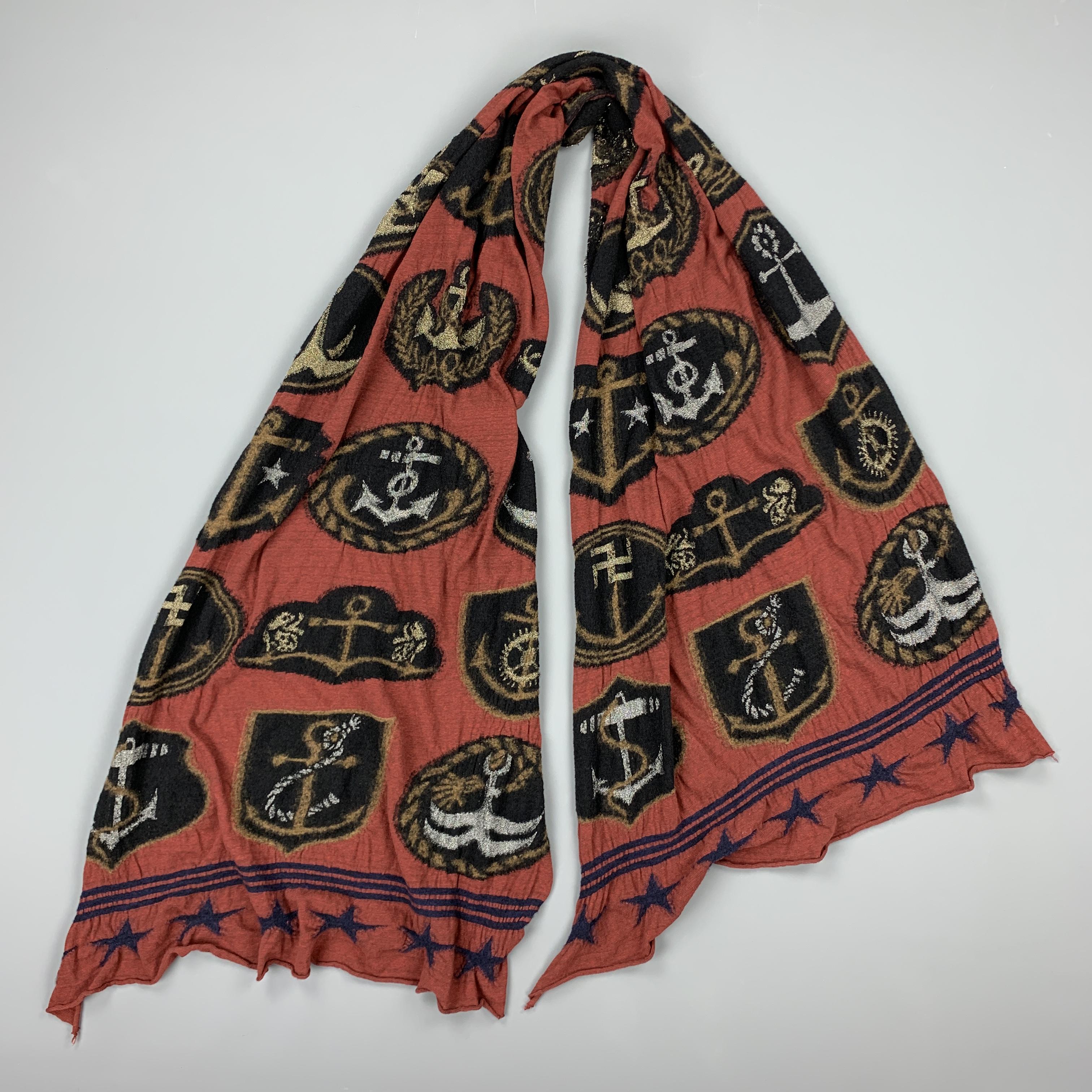 KAPITAL scarf comes in a brick wool jersey textured knit with black and gold and silver metallic anchor print throughout. 

Excellent Pre-Owned Condition.

Length: 96 in.
Width: 29 in.
