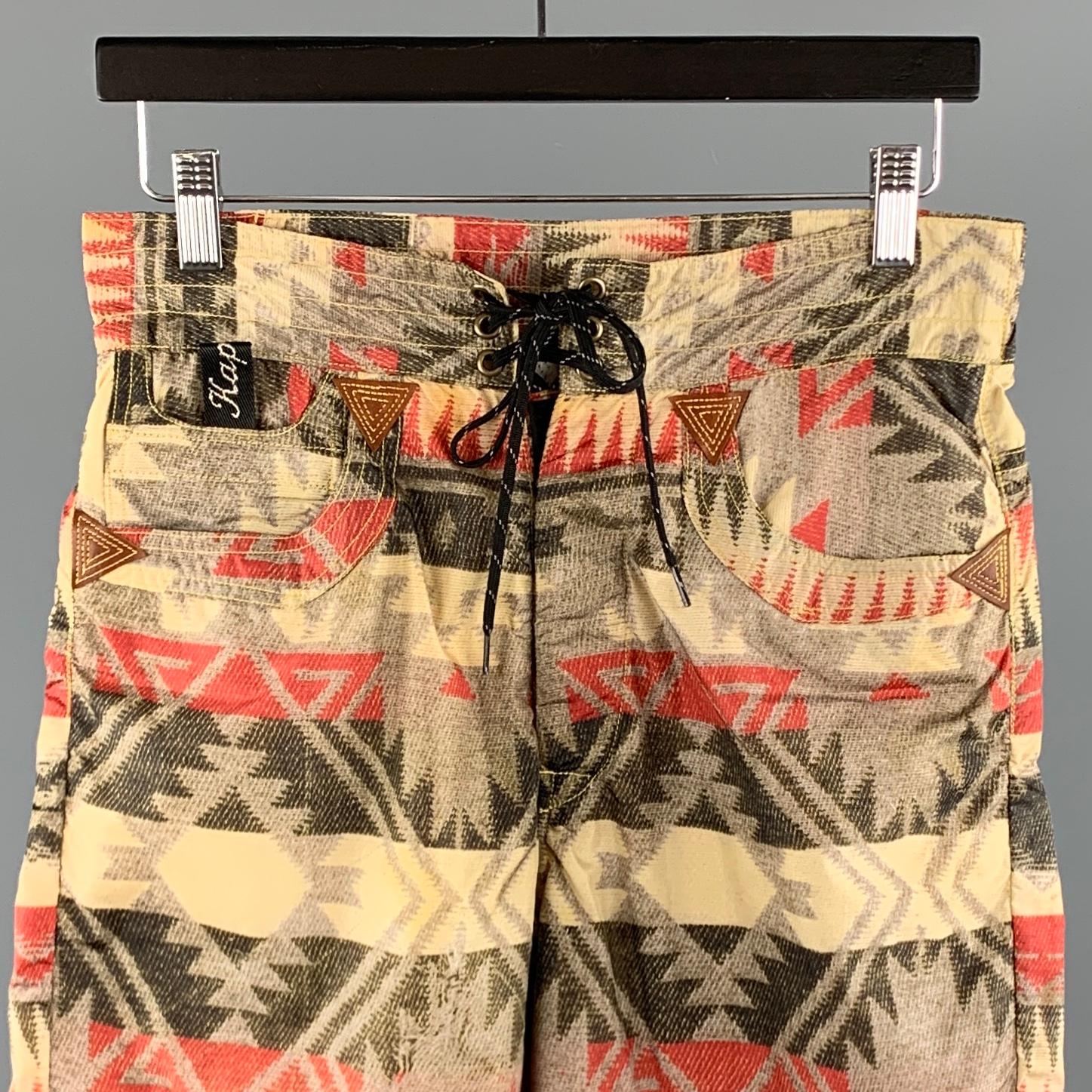 KAPITAL Swim Trunks comes in a khaki print nylon featuring a drawstring closure, lined, contrast stitching, and a back strap detail. Made in Japan. 

New With Tags.
Marked: 2

Measurements:

Waist: 30 in. 
Rise: 11 in.
Inseam: 7.5 in. 