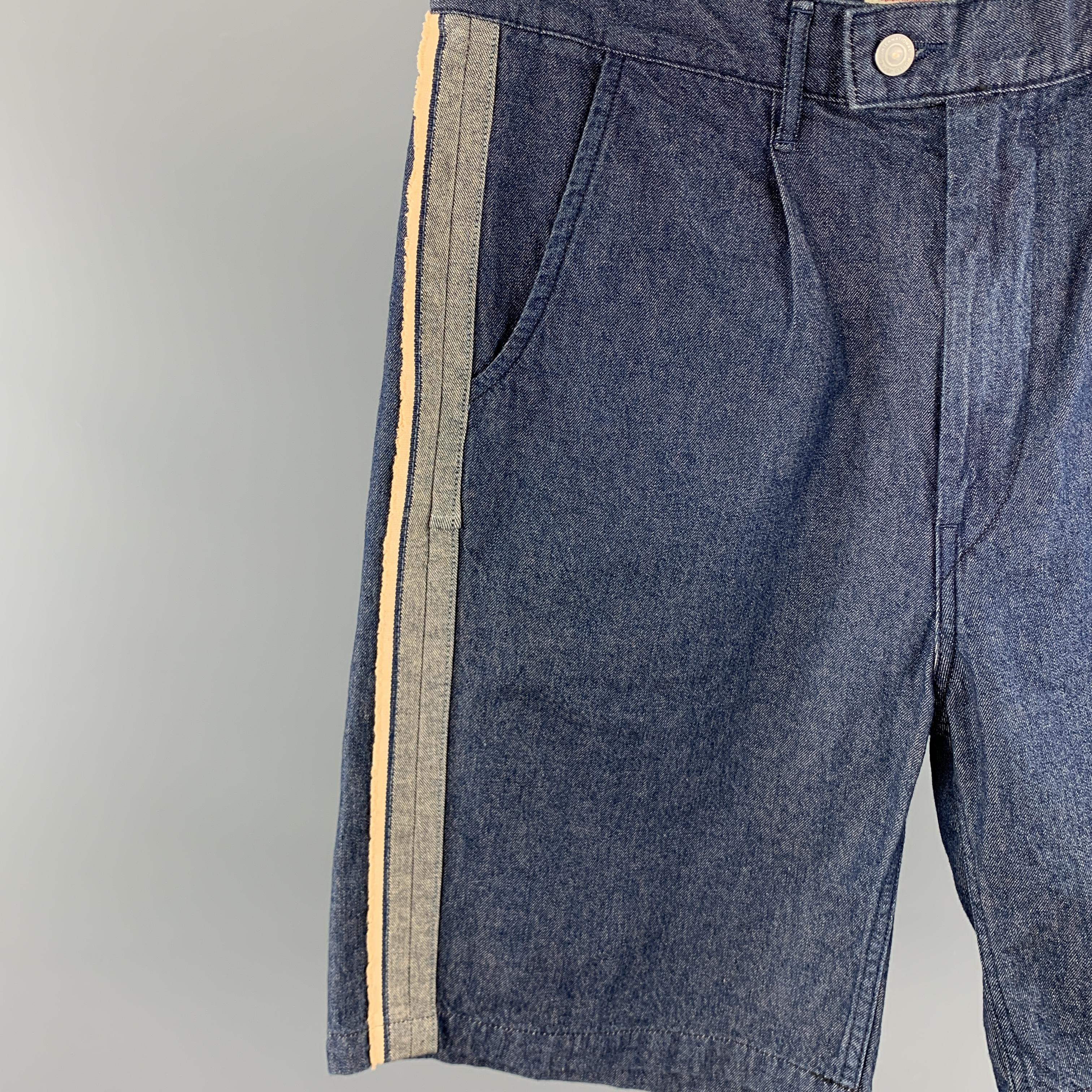 KAPITAL Shorts comes in a indigo cotton featuring side pleated details, contrast stitching, and a zip fly closure. Made in Japan. 

New With Tags.
Marked: 4

Original Retail Price: $218.00

Measurements:

Waist: 34 in. 
Rise: 12 in. 
Inseam: 9 in. 

