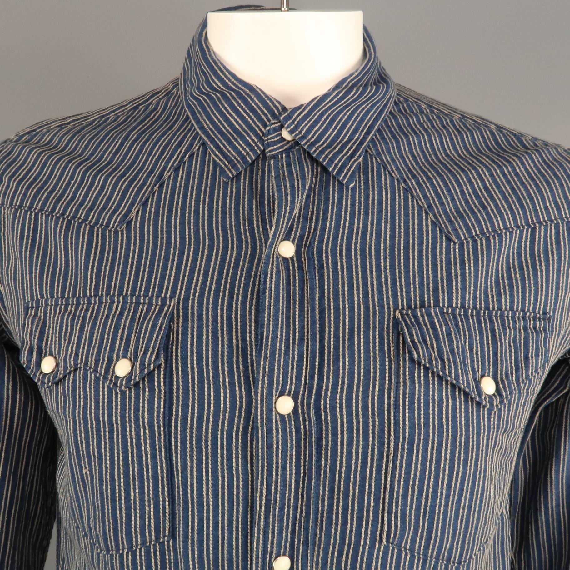 KAPITAL long sleeve shirt comes in a navy and gold striped cotton featuring a button up style, snap closure, and shoulder patch details. Made in Japan.
 
Excellent Pre-Owned Condition.
Marked: JP 3
 
Measurements:
 
Shoulder: 19 in.
Chest: 42