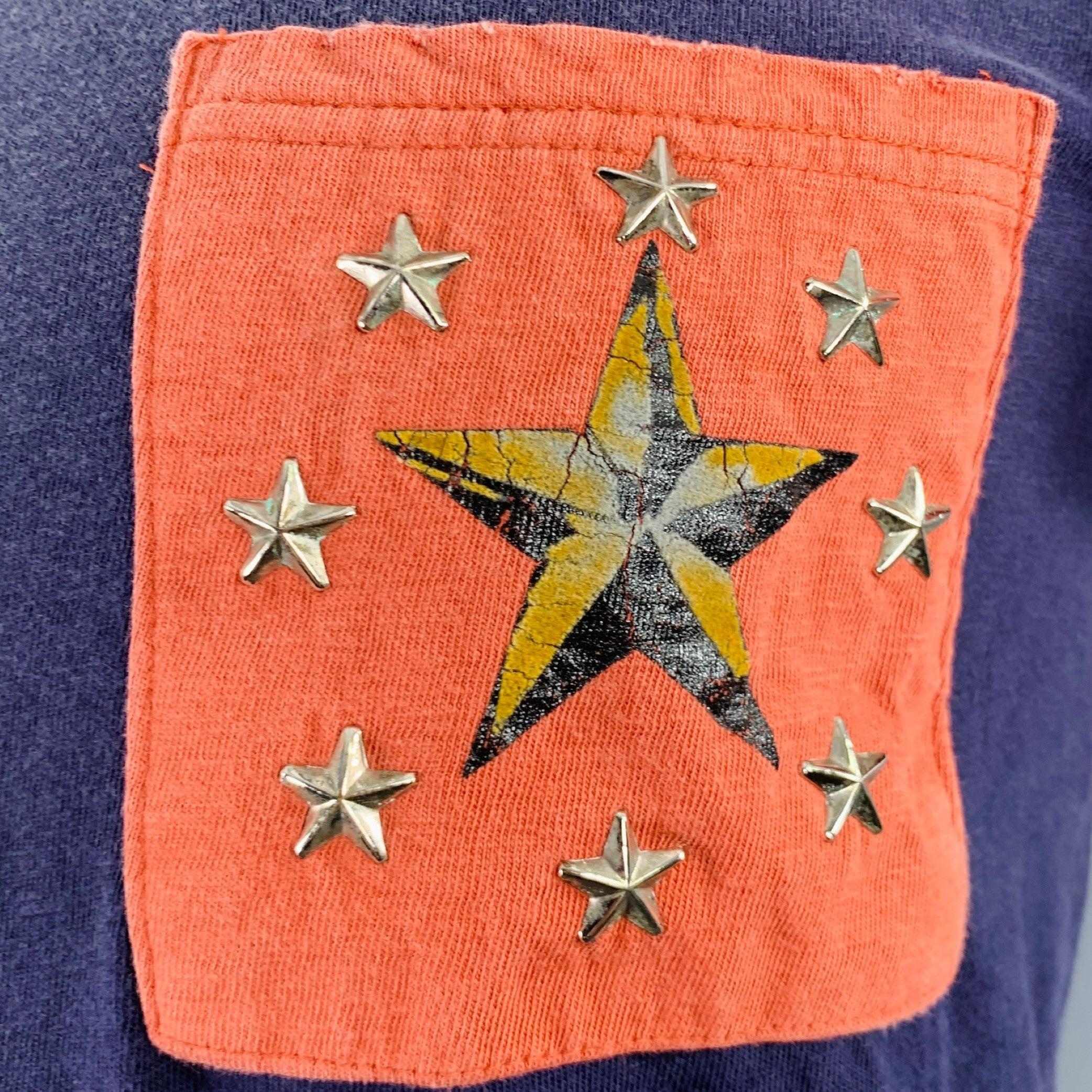 KAPITAL t-shirt
in a navy and red cotton jersey featuring a color black style, one pocket with a printed and silver tone metal stars, and crew neck. Made in Japan.Very Good Pre-Owned Condition. Minor signs of wear, particularly on metal stars.