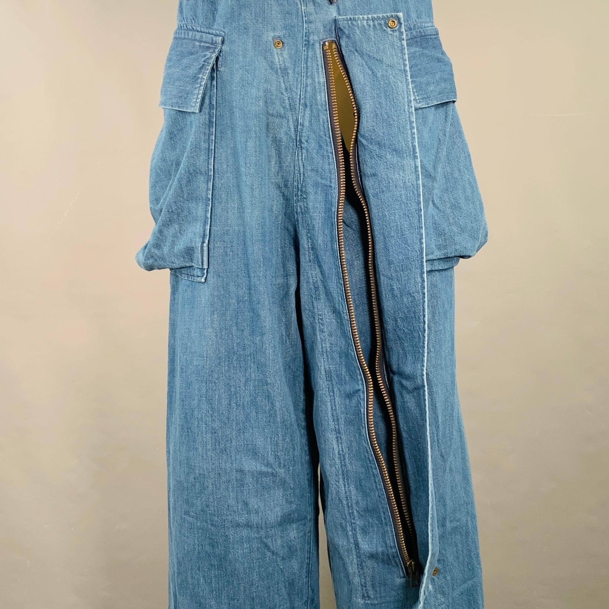 KAPITAL casual pants in an indigo wash cotton featuring a cargo style with large buttoned pockets, extra long flap opening details on front and back, and drawstring waistband. Made in Japan.Excellent Pre-Owned Condition. 

Marked:   JP 2