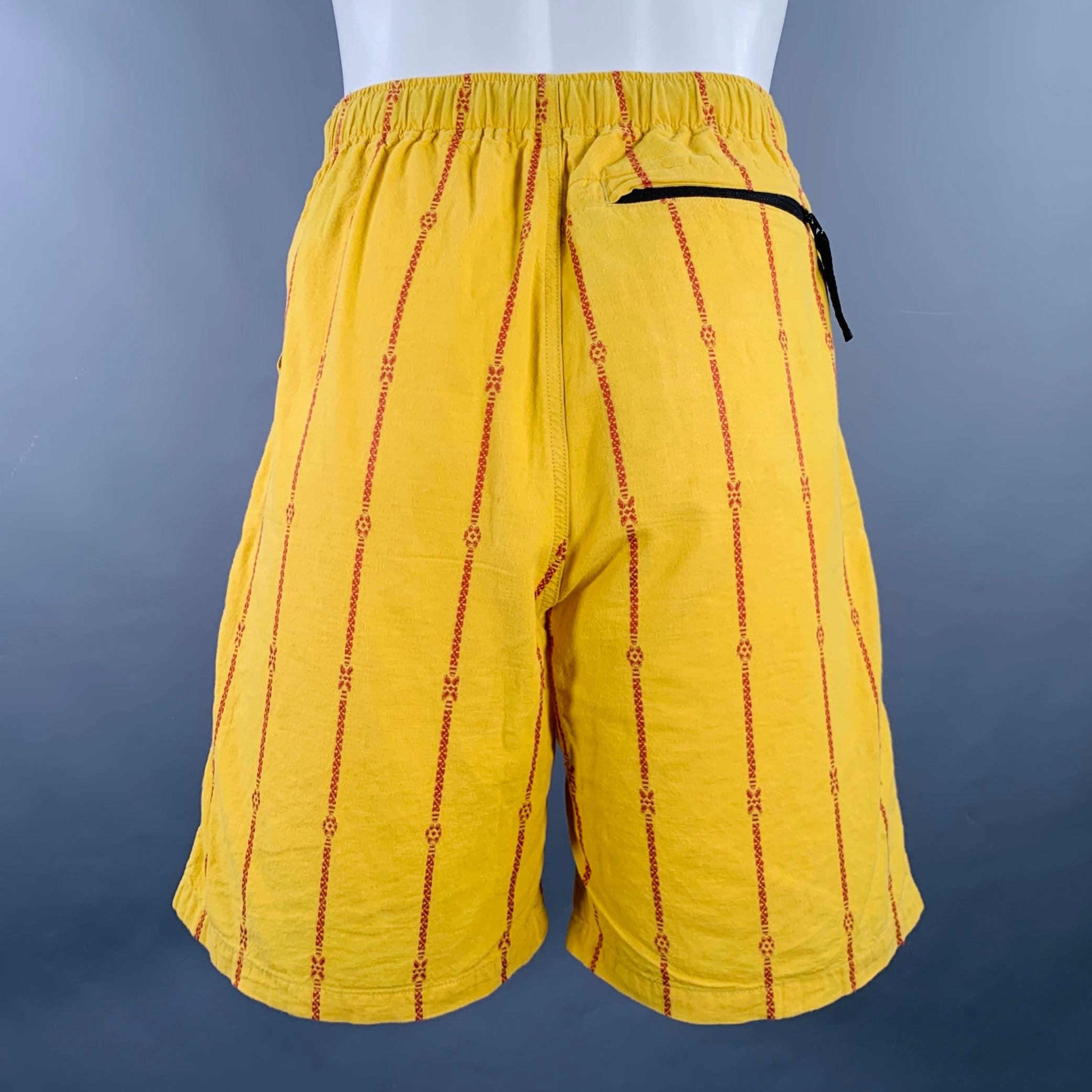 KAPITAL shorts
in a yellow cotton linen woven fabric featuring an orange stripe pattern, three pockets, and drawstring closure with branded KAPITAL belt. Made in Japan.Very Good Pre-Owned Condition. Minor mark. 

Marked:   JP 2 

Measurements: 
 