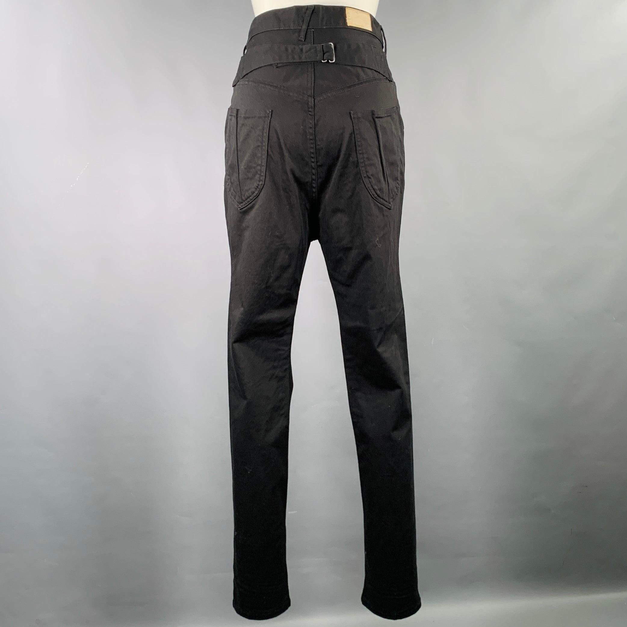 KAPITAL casual pants
in a black cotton polyurethane fabric featuring a drop crotch style, five pockets, and zip fly closure. Made in Japan.Excellent Pre-Owned Condition. 

Marked:   JP 1 

Measurements: 
  Waist: 29 inches Rise: 13.5 inches Inseam: