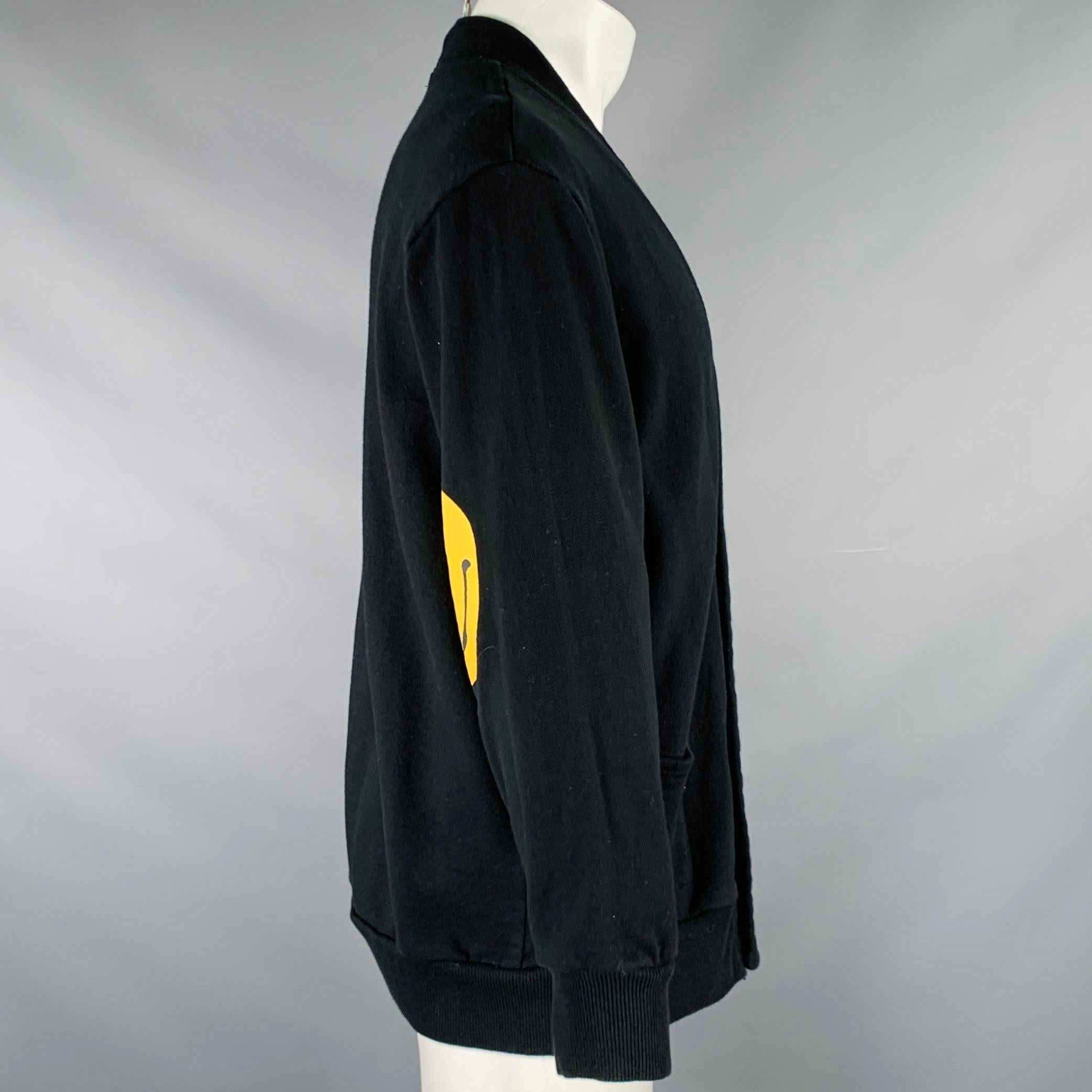 KAPITAL jacket
in a black cotton knit featuring yellow happy face elbow prints, V-neck, two pockets, and snap closure. Made in Japan.Very Good Pre-Owned Condition. Minor signs of wear. 

Marked:   JP 1 

Measurements: 
 
Shoulder: 19 inches Chest: