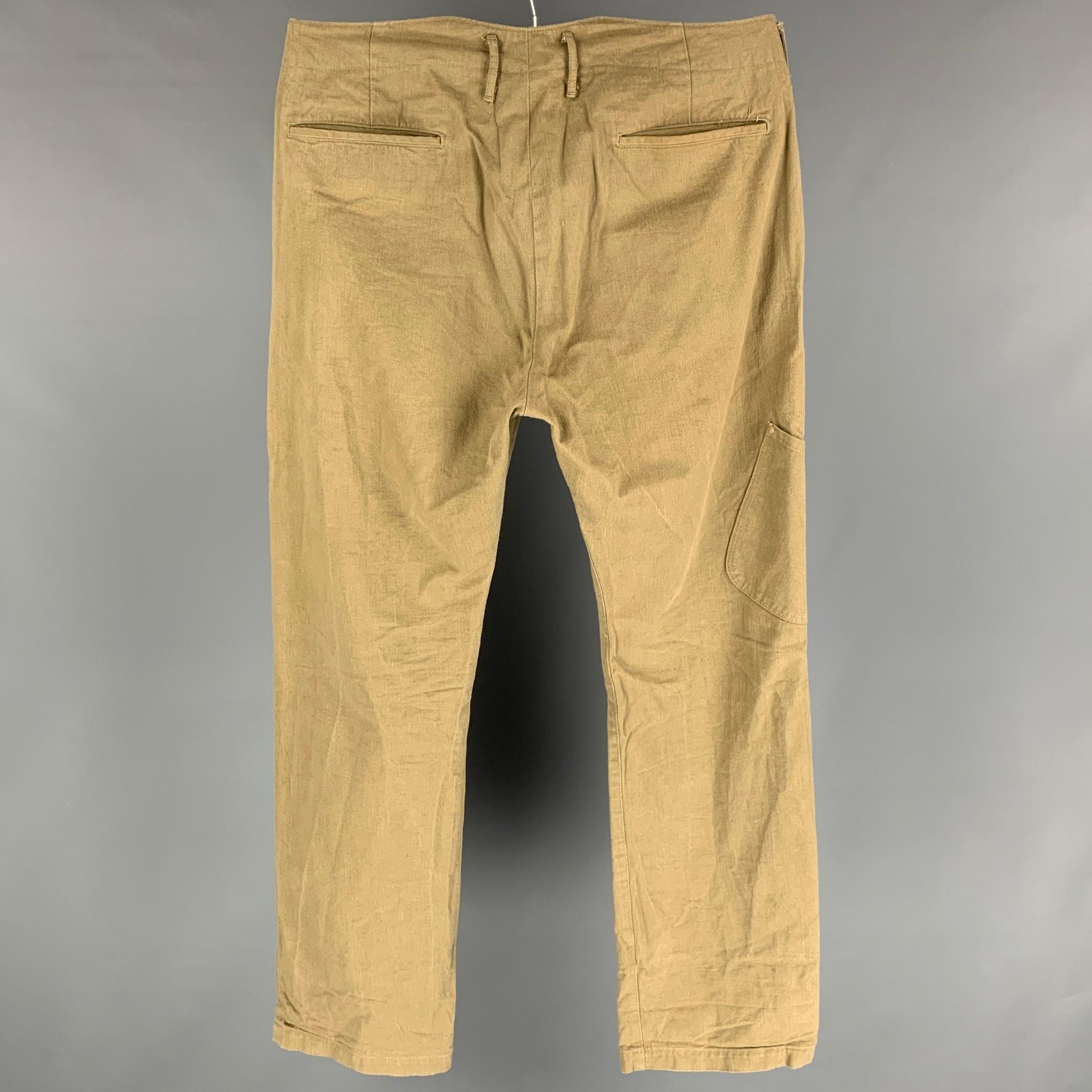 KAPITAL casual pants comes in a khaki cotton featuring a wide leg style, side pocket detail, and a button fly closure. 

Very Good Pre-Owned Condition.
Marked: 4

Measurements:

Waist: 36 in.
Rise: 13.5 in.
Inseam: 35 in. 