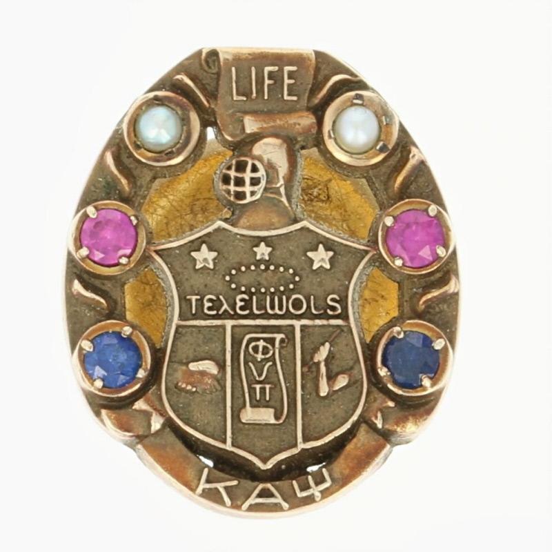 Fraternity Founded in 1911.
Badge Type: Life Membership
Stamps: 10k 
Metal Content: Guaranteed 10k Gold as tested and stamped (with base metal clutch)

Stone Information:
Genuine Seed Pearls - 
Diameter: 1.5mm

Synthetic Rubies & Sapphires -