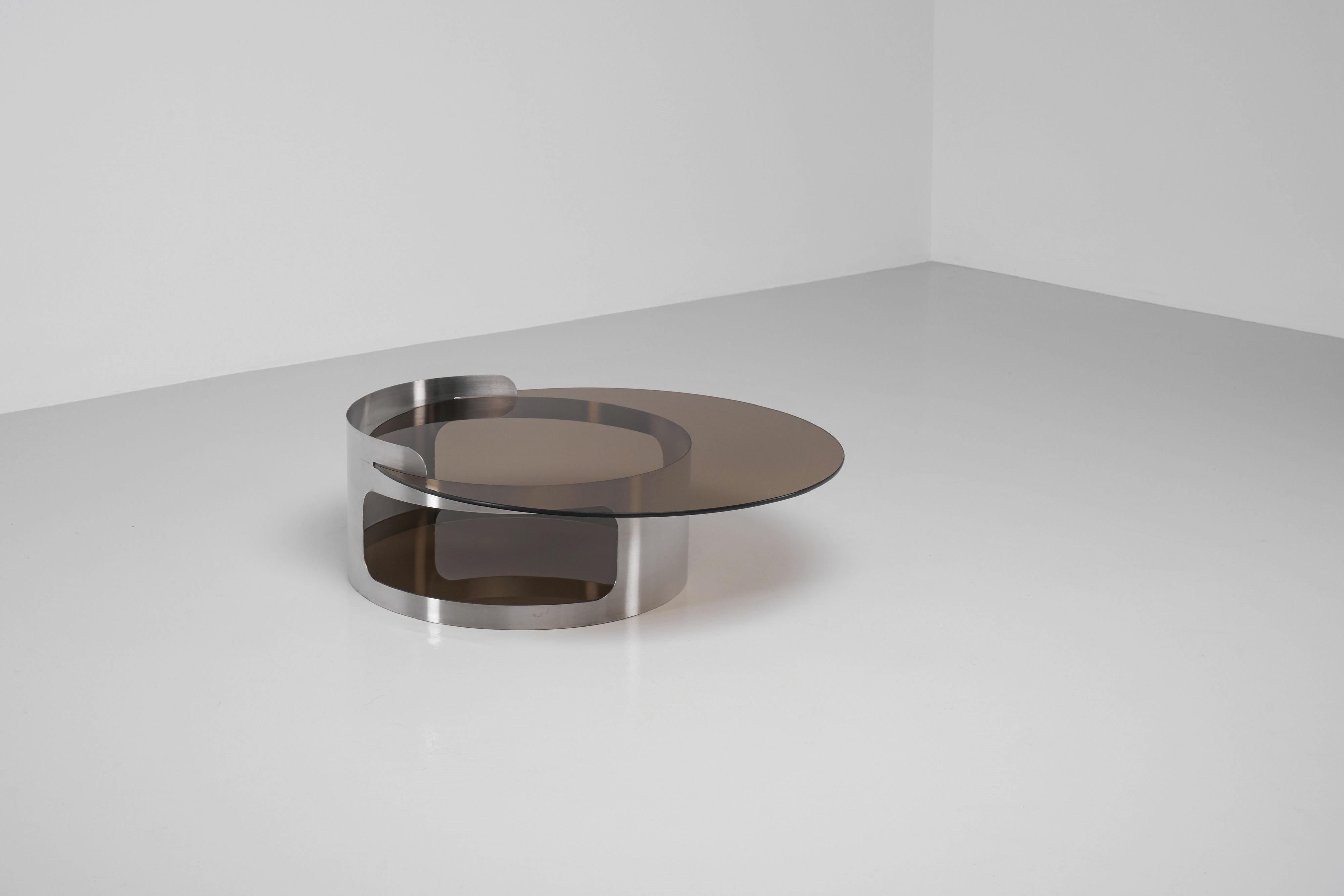 A typical seventies coffee table designed by unknown designer and manufactured by Kappa, France 1970s. This amazing asymmetrical coffee table has a stainless-steel ring-shaped structure and is finished with smoked glass tops. These materials were