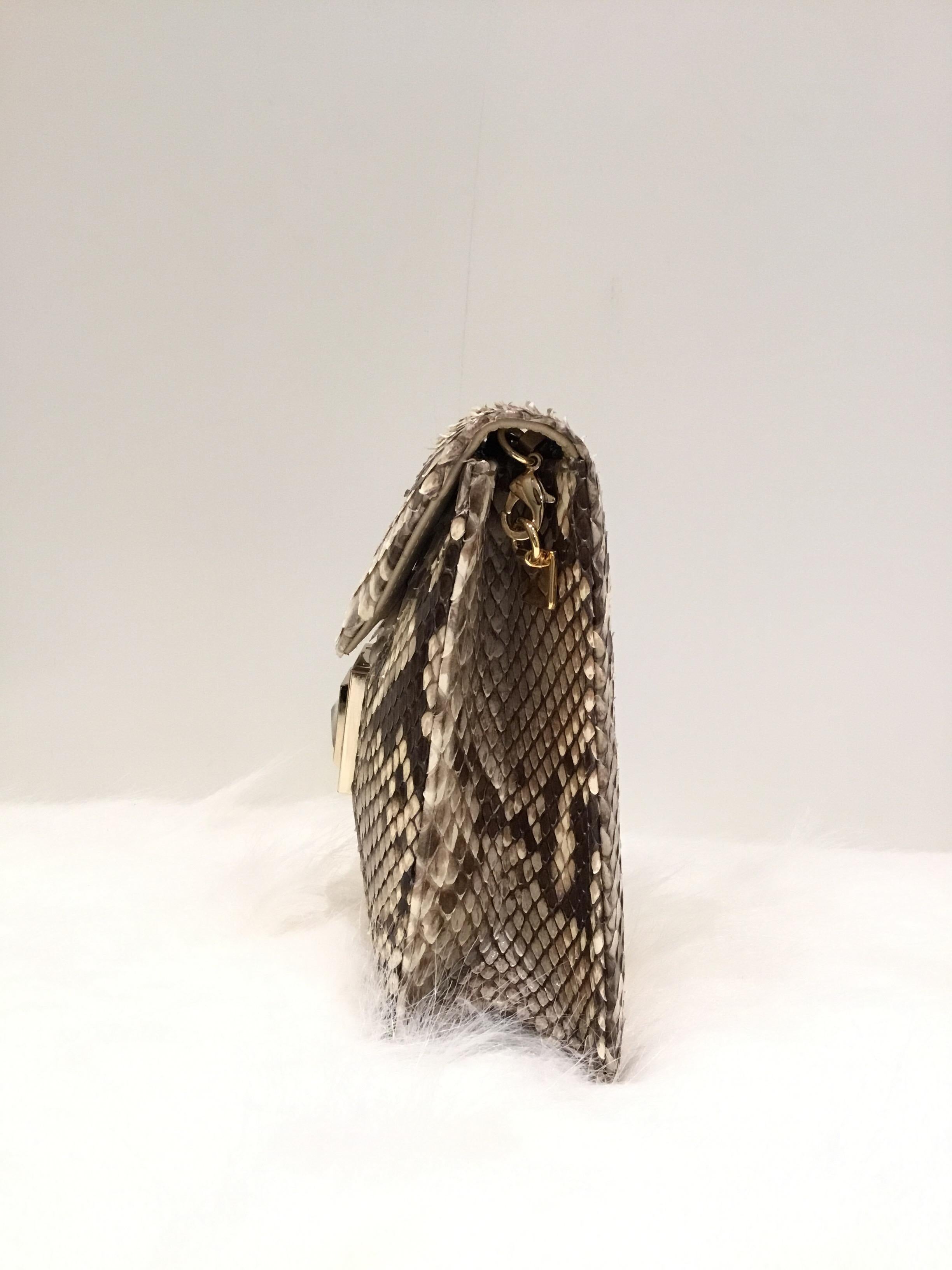 Kara Ross Python snakeskin bag with a magnetic flap closure and a gold-tone chain handle. Made in USA.

Measurements: 
4” x 2” x 6”