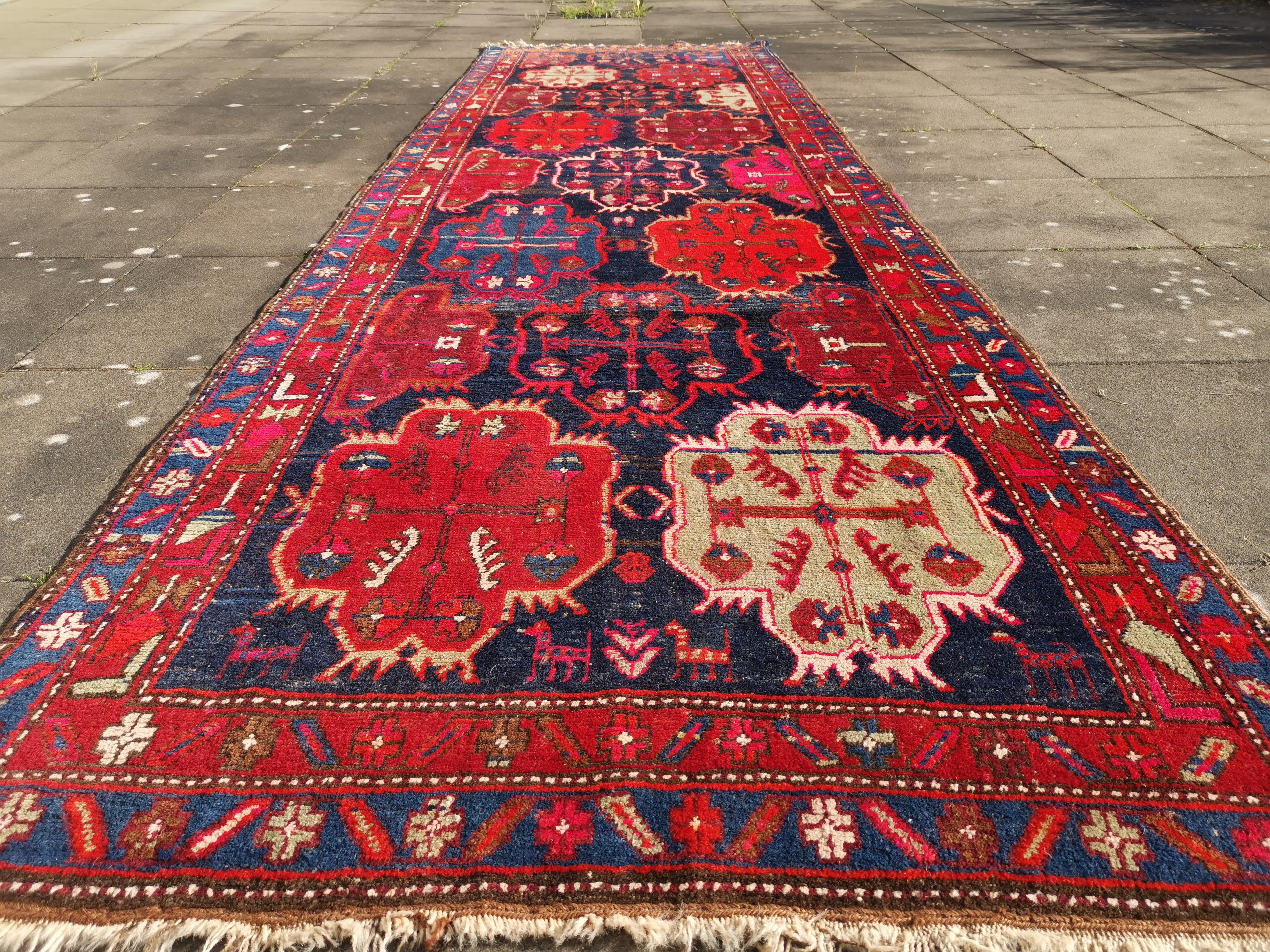 Karabagh semi antique Caucasian rug.

A beautiful antique rug from Azerbeijan.
• Beautiful colors, very vibrant
• All handmade
• Pile pure wool
• Traditional design
• Condition: Very good, wool pile on wool warp and weft. Worn to