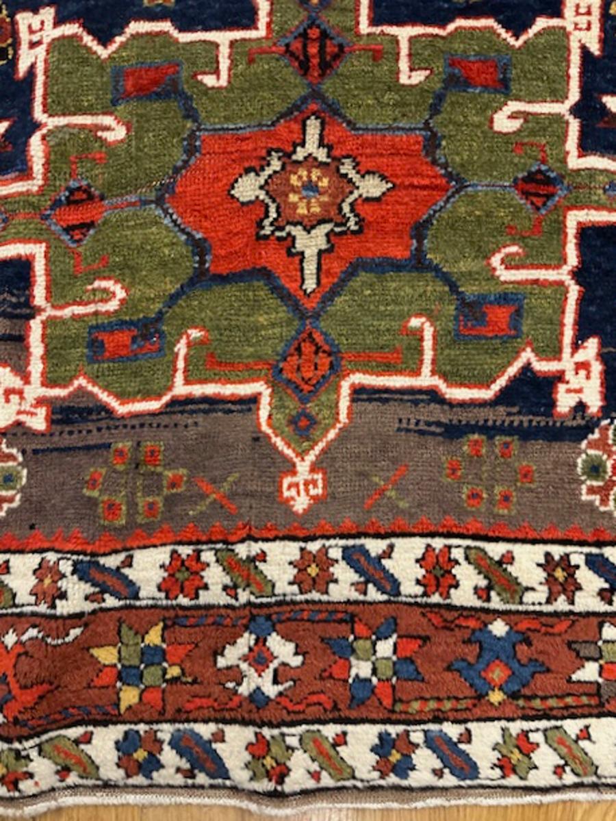 Karadagh runner (detail) from Azerbaijan province,north west Persia (Iran)

Age: circa 1880

Size: 14′.9″x3′.7″ (450×109 cm)

The deep blue ground displays a pole medallion of twelve varying devices,all characteristic of the area.The red border of