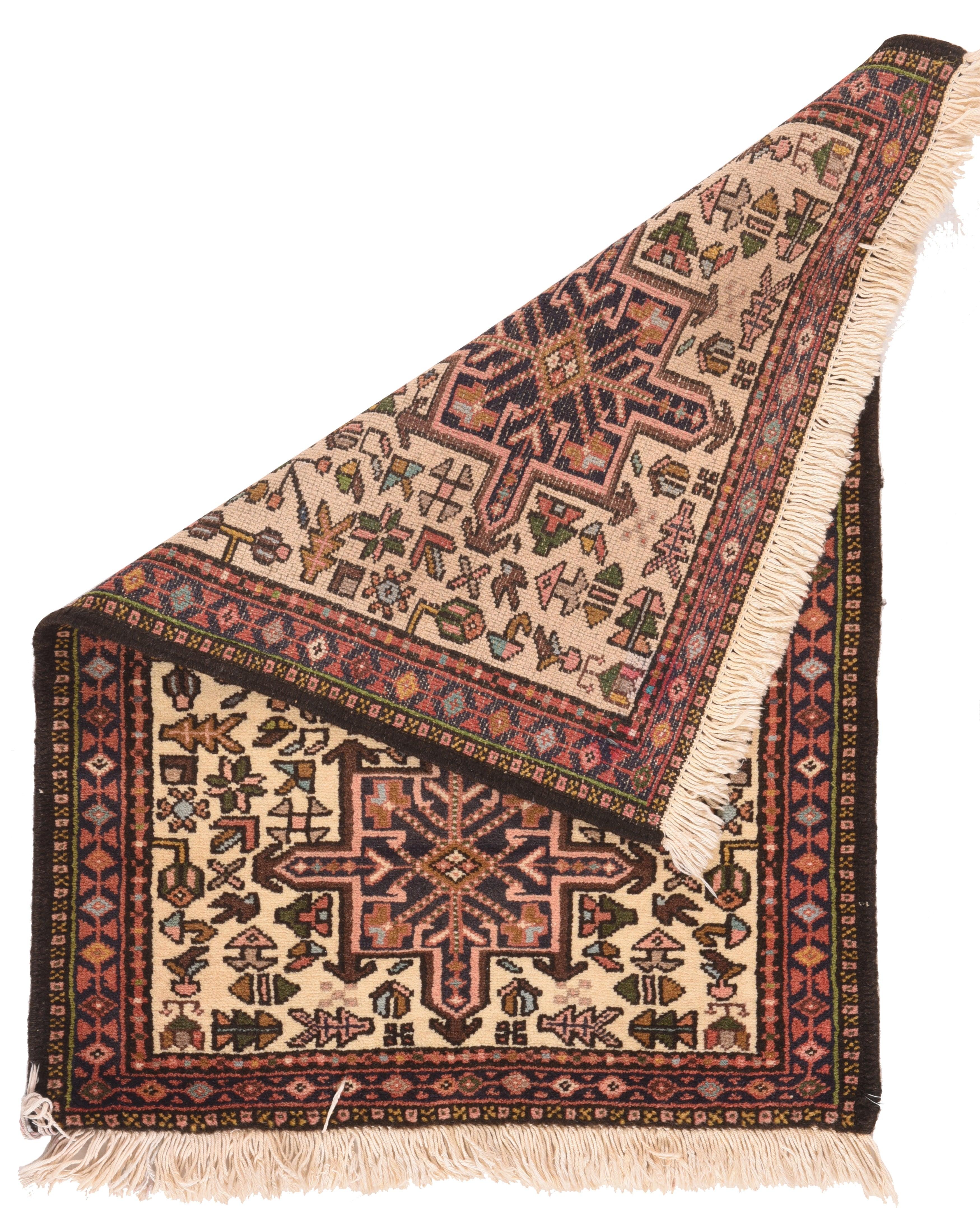Karajeh Rug 2'4'' x 2'11''. The characteristic Karaja pattern of octogrammes and hooked hexagons is exemplified by this small scatter in brown-black and coral, on the creamy ecru ground. Close supporting semi-geometric floral back fill scatter.