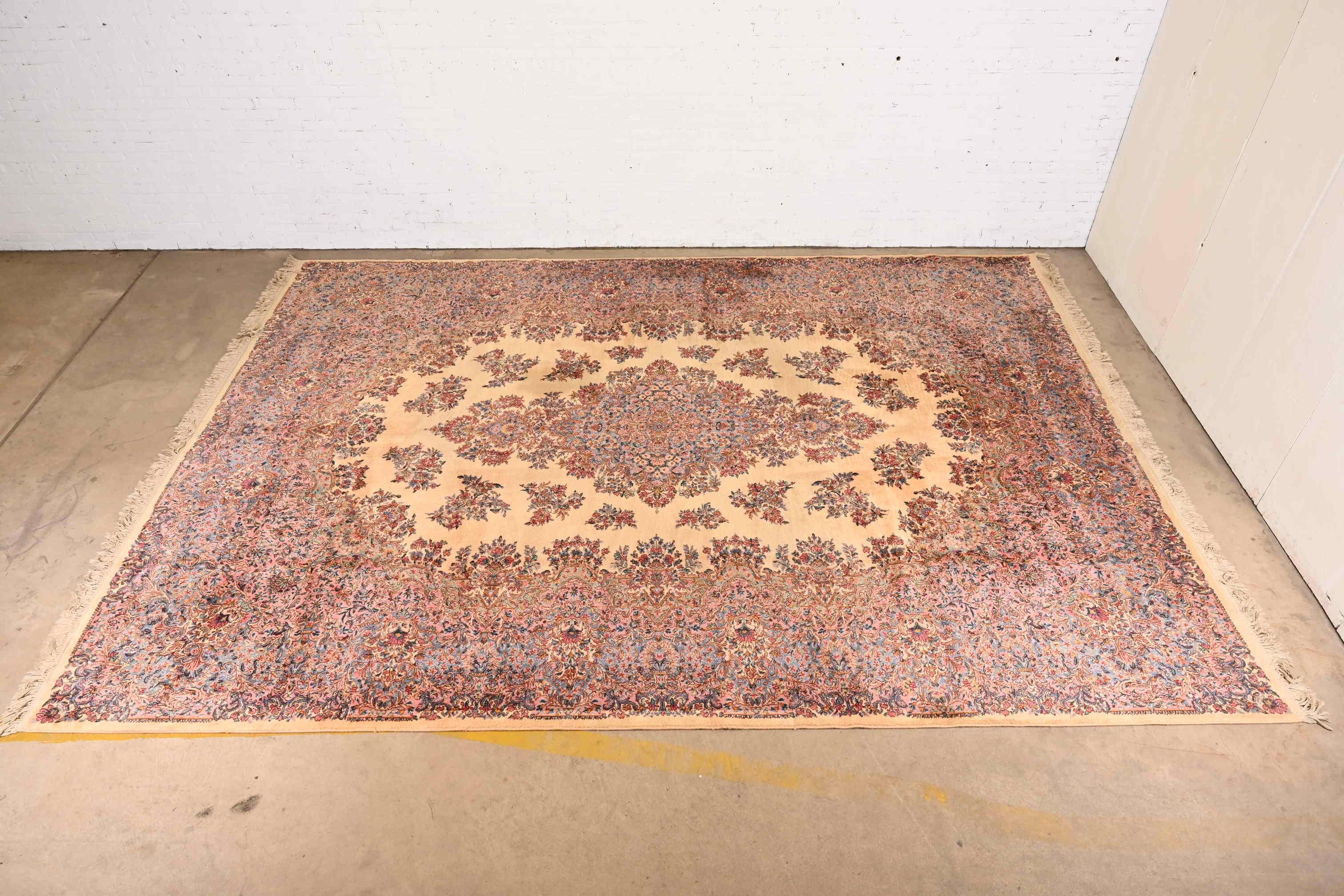 A gorrgeous Persian Kirman style room size wool area rug

By Karastan

USA, circa 1940s

Features a beautiful floral pattern, with center medallion. Predominant colors in pink, blue, and cream.

Measures: 11'6