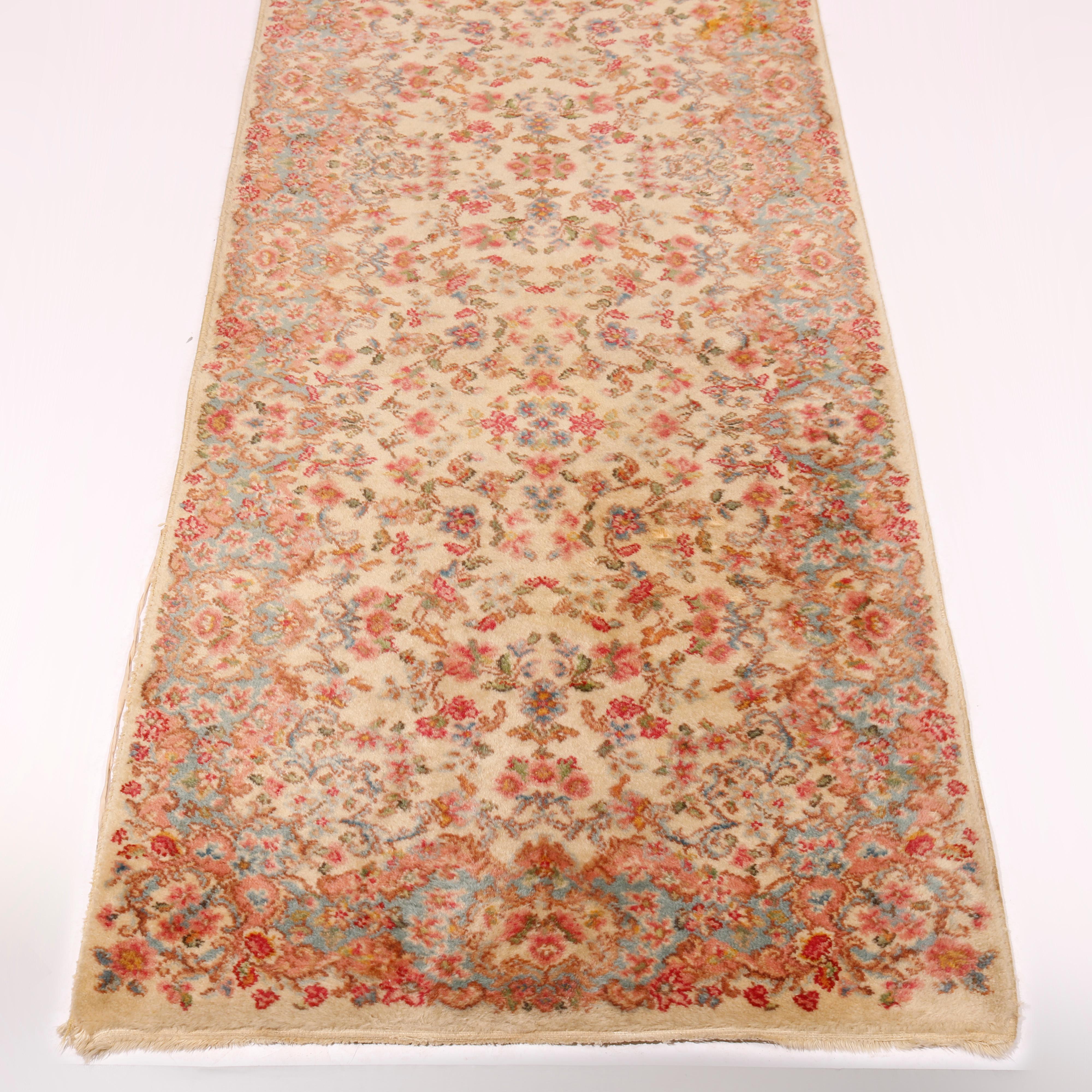 A Karastan Kirman oriental rug runner in Pattern 788 offers wool construction with floral spray throughout, maker label as photographed, circa 1950

Measures - 179'' L x 34.5'' W x .5''.