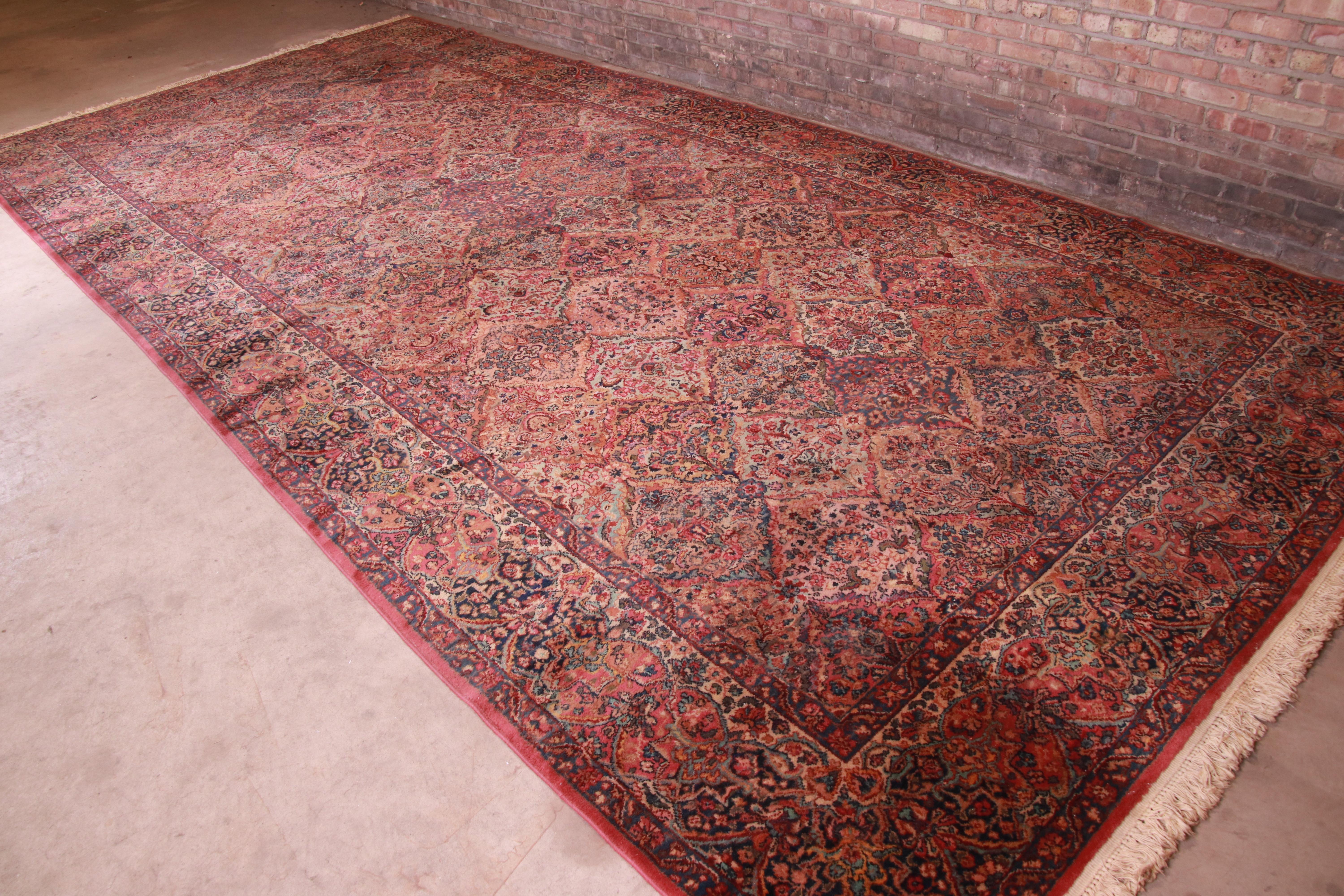 An exceptional Persian Kirman style room size rug

By Karastan

USA, circa 1940s

Features a beautiful all-over patchwork pattern containing myriad flowers woven in myriad colors across the field, and surrounded by a border of similar pattern