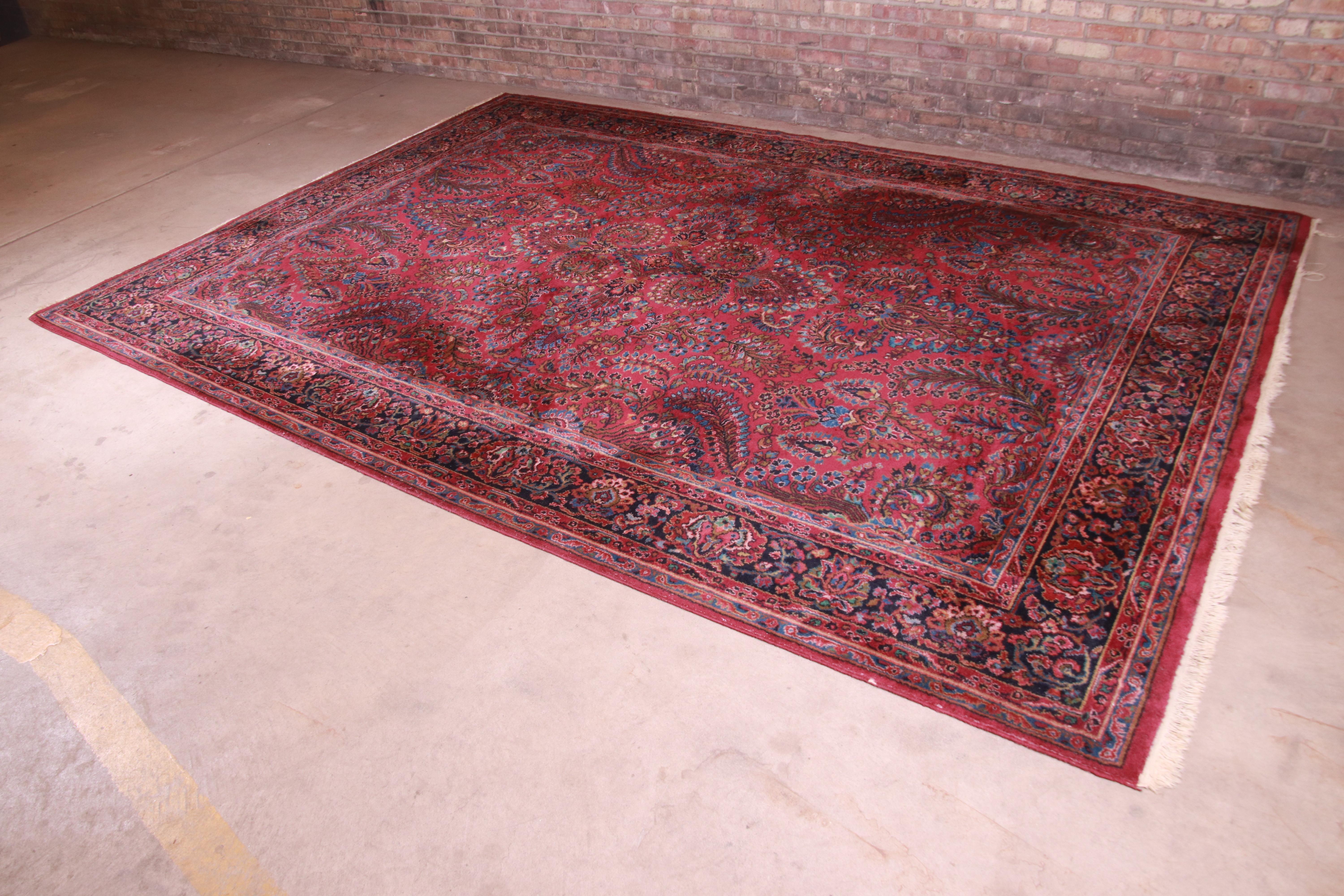 A beautiful Persian Sarouk style room size rug.

By Karastan,

USA, circa 1940s

Classic design with floral sprays and bouquets

Measures: 8'8