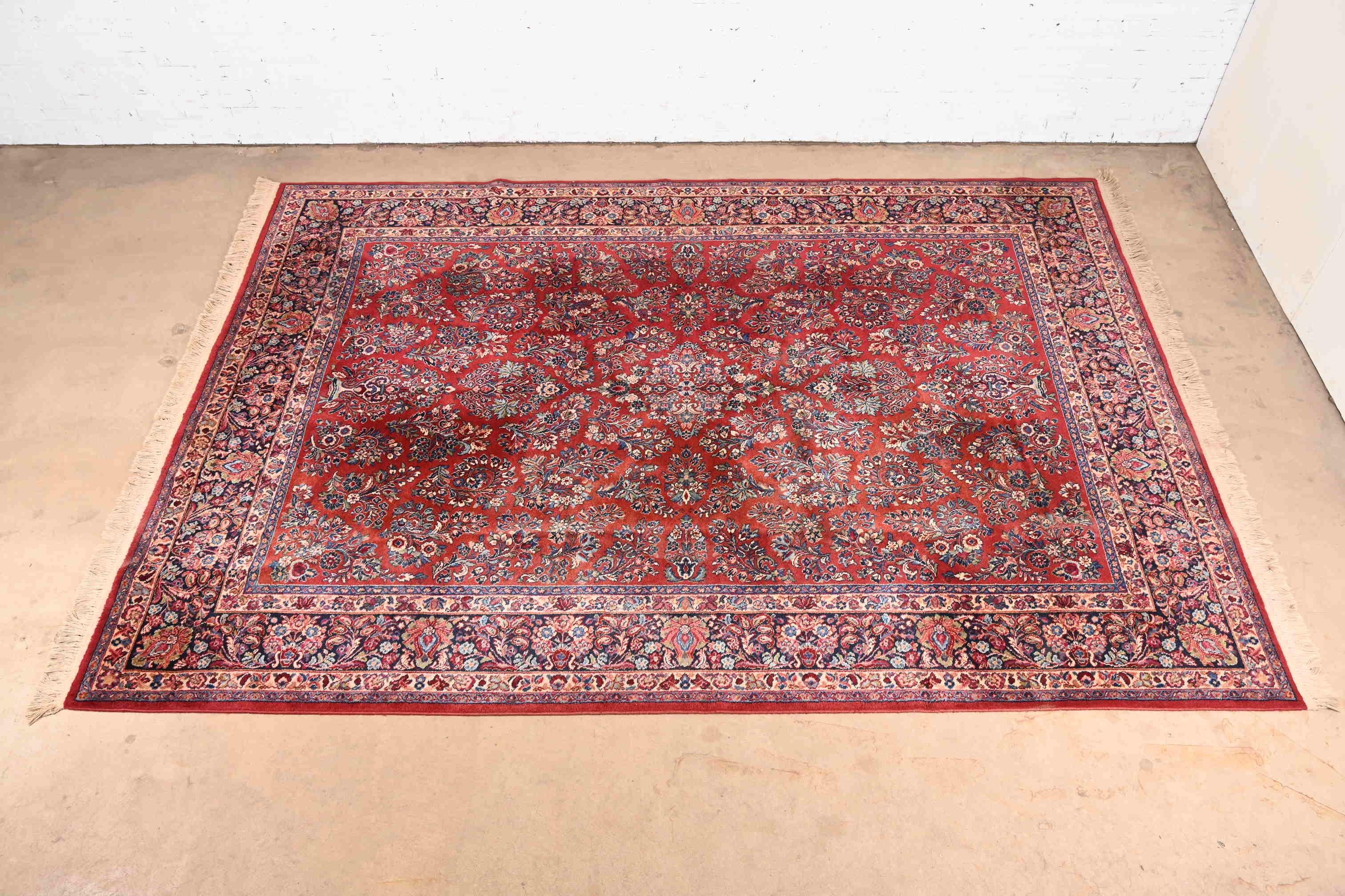 An exceptional Persian Sarouk style room size rug

By Karastan

USA, circa 1950s

Features beautiful traditional floral sprays and bouquets, with predominant colors in red, blue, and ivory.

Measures: 8