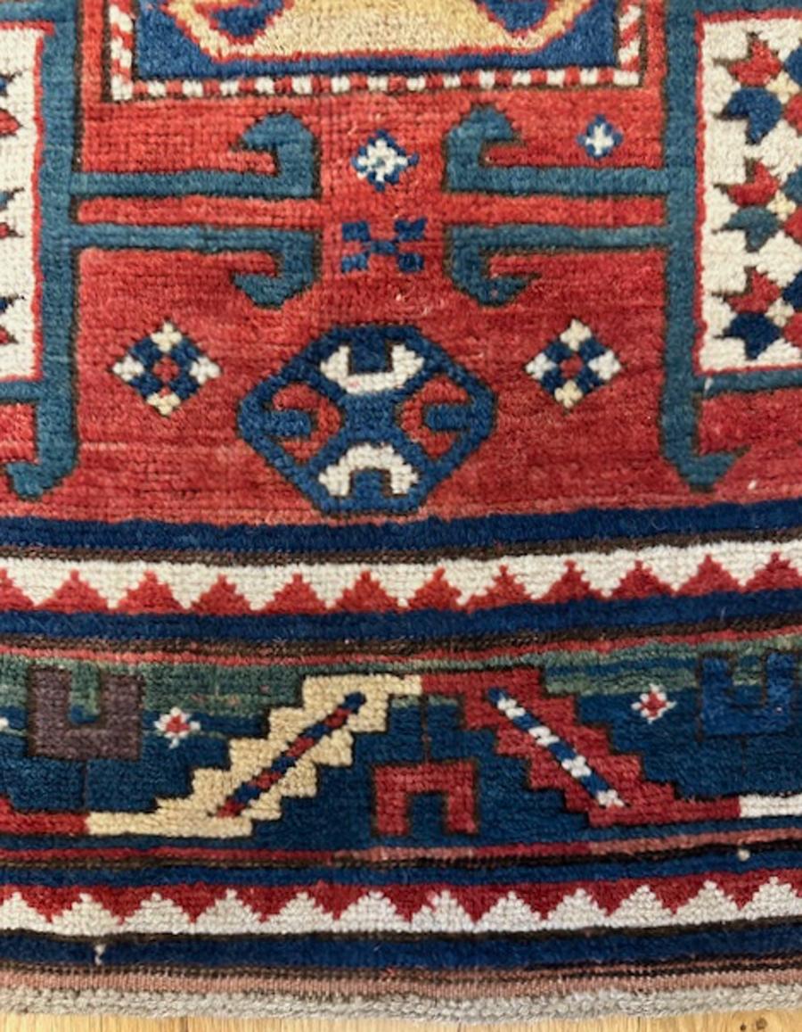 Karatchoph Kazak rug from Armenia,southwest Caucasus

Age: circa 1880

Measurements: 6′.6″X5′.0″ (198X152 cm)

The attractive abrashed red field is centered by an ivory octagonal medallion which contains a dark blue en suite central motif.The