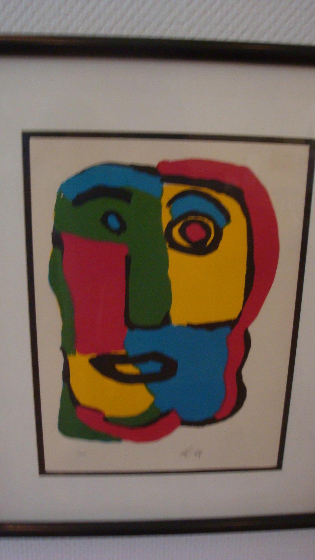 This is a colorful face lithograph done by Karel Appel in the 1970s.
 It is numbered 1/300 and signed with the initials K A.
