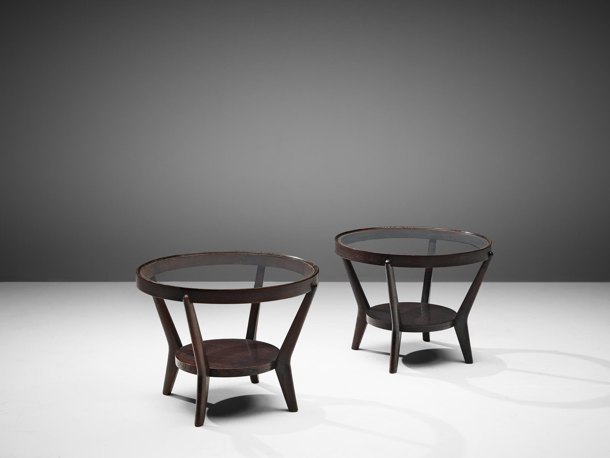 Karel Koželka and Antonín Kropácek for Interier Praha, coffee tables, dark stained oak and glass, Czech Republic, produced 1960s.

An iconic Czechoslovak design piece by designers Karel Kozelka and Antonin Kropacek of the 1950s. The tables have a