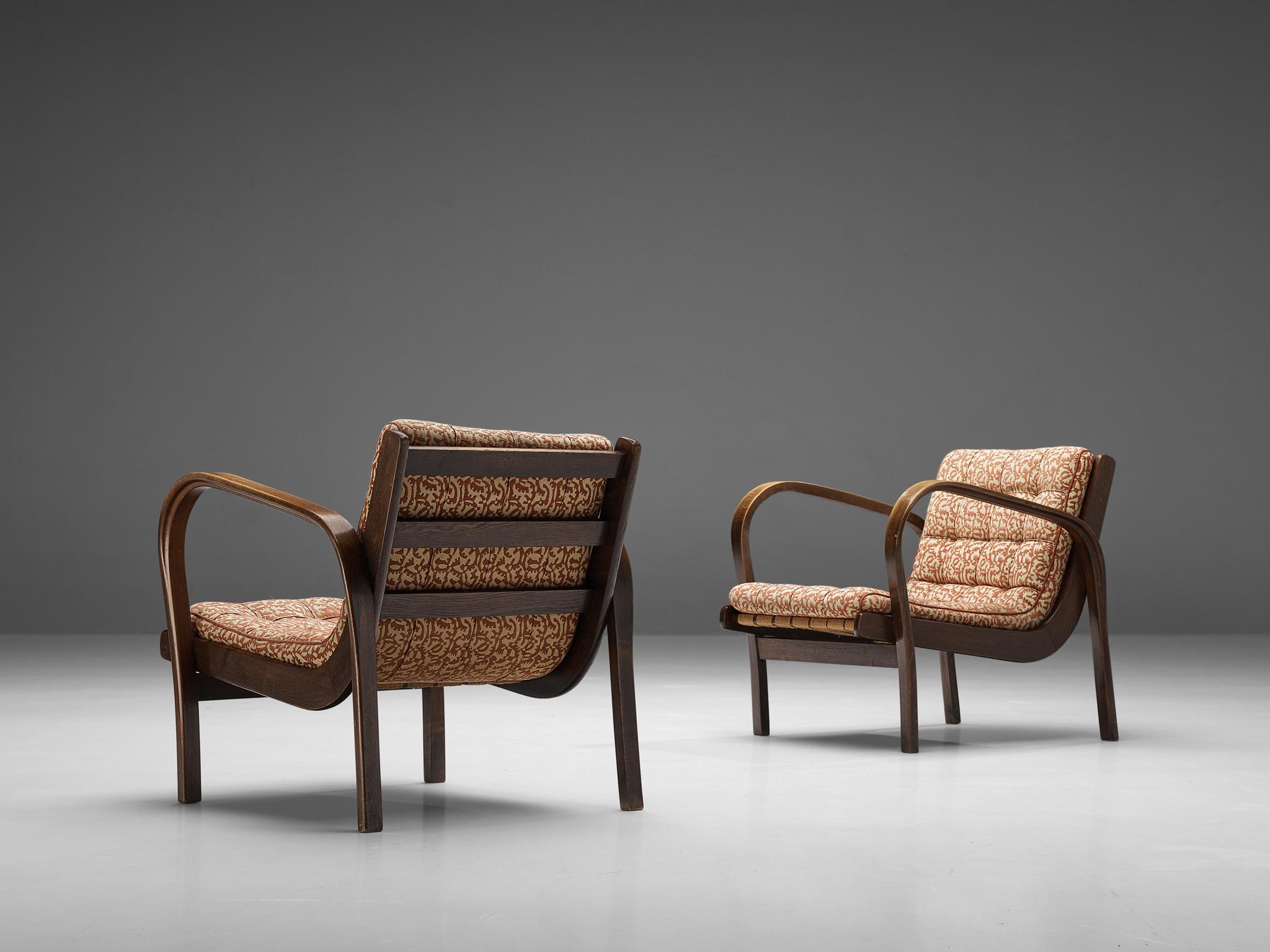 Karel Kozelka and Antonín Kropácek for Interiér Praha, lounge chairs, stained beech, fabric, Czech Republic, 1940s

Wonderful armchairs by Kozelka and Kropácek designed and manufactured in the 1940s. Two legs float over into the beautifully curved