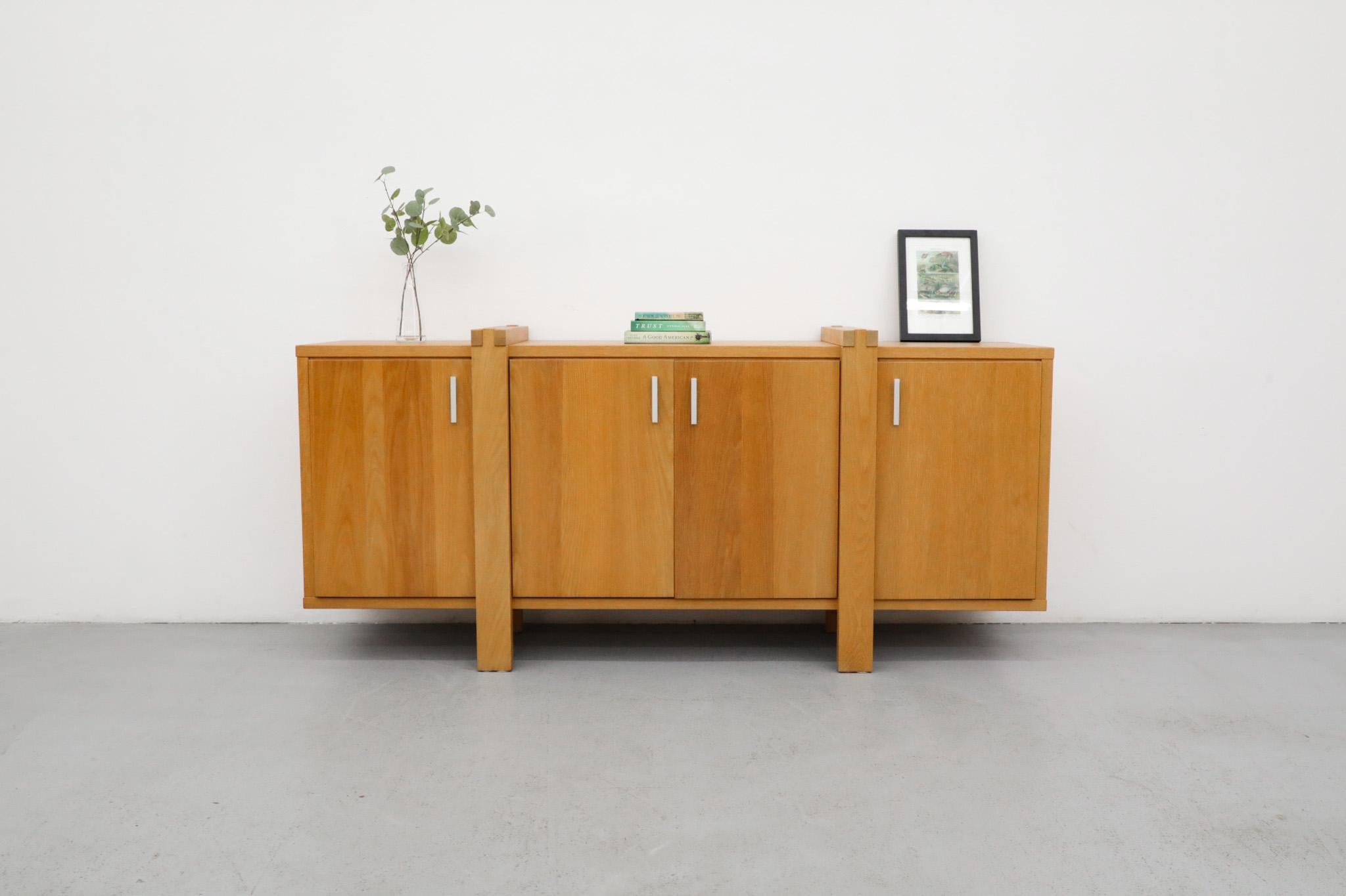 Karel Mintjens Brutalist Oak sideboard with linear cast aluminum pulls, 4 storage cabinets and box joint detail. Handsome construction with legs that seemingly wrap around the piece. In original condition with visible wear including some scratching.