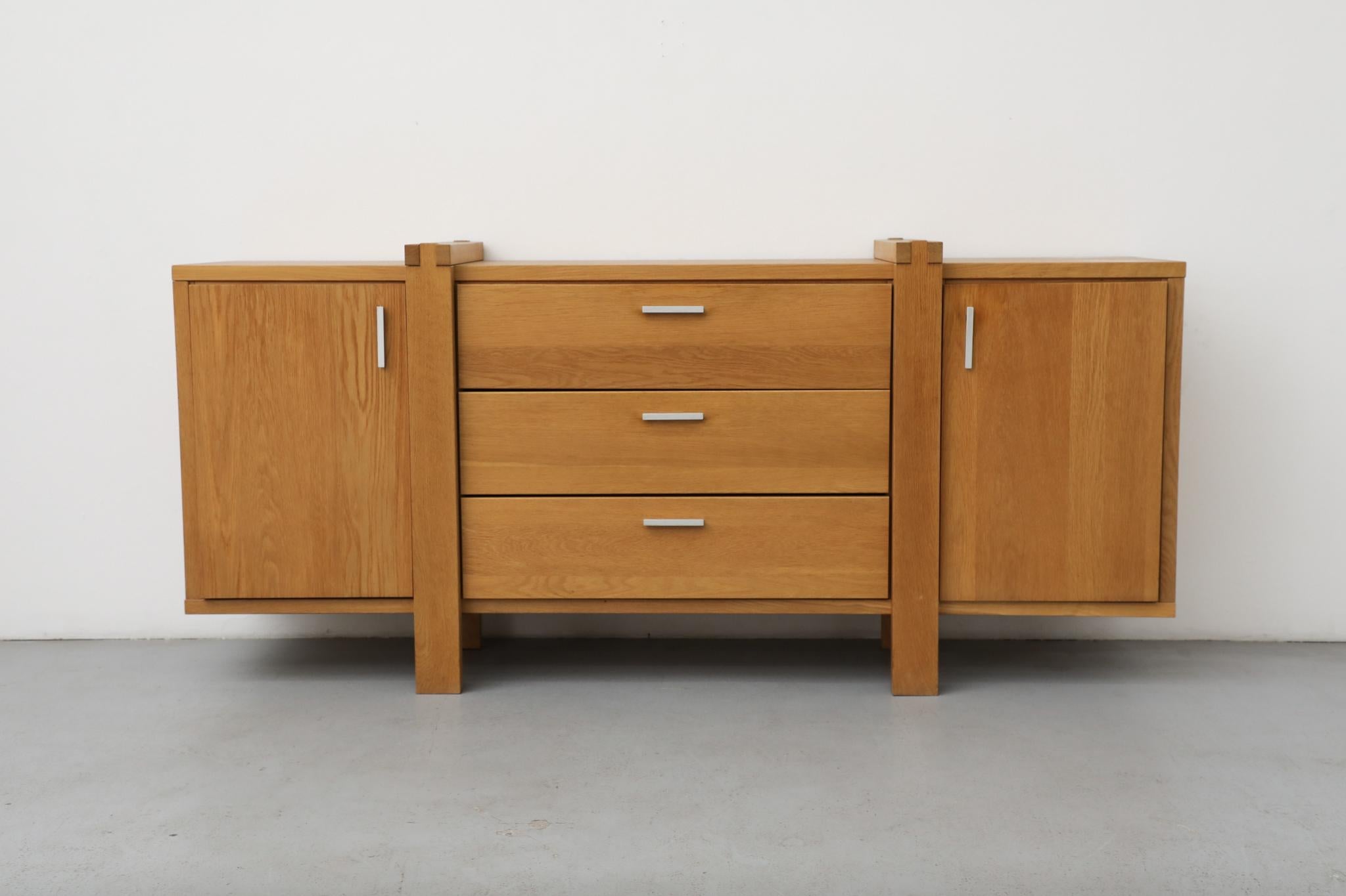 Karel Mintjens Brutalist Oak sideboard with aluminum pulls, 2 storage cabinets and 3 drawers. Lovely box joint detail. Handsome construction with legs that wrap around the piece. In original condition with visible wear including some scratching.